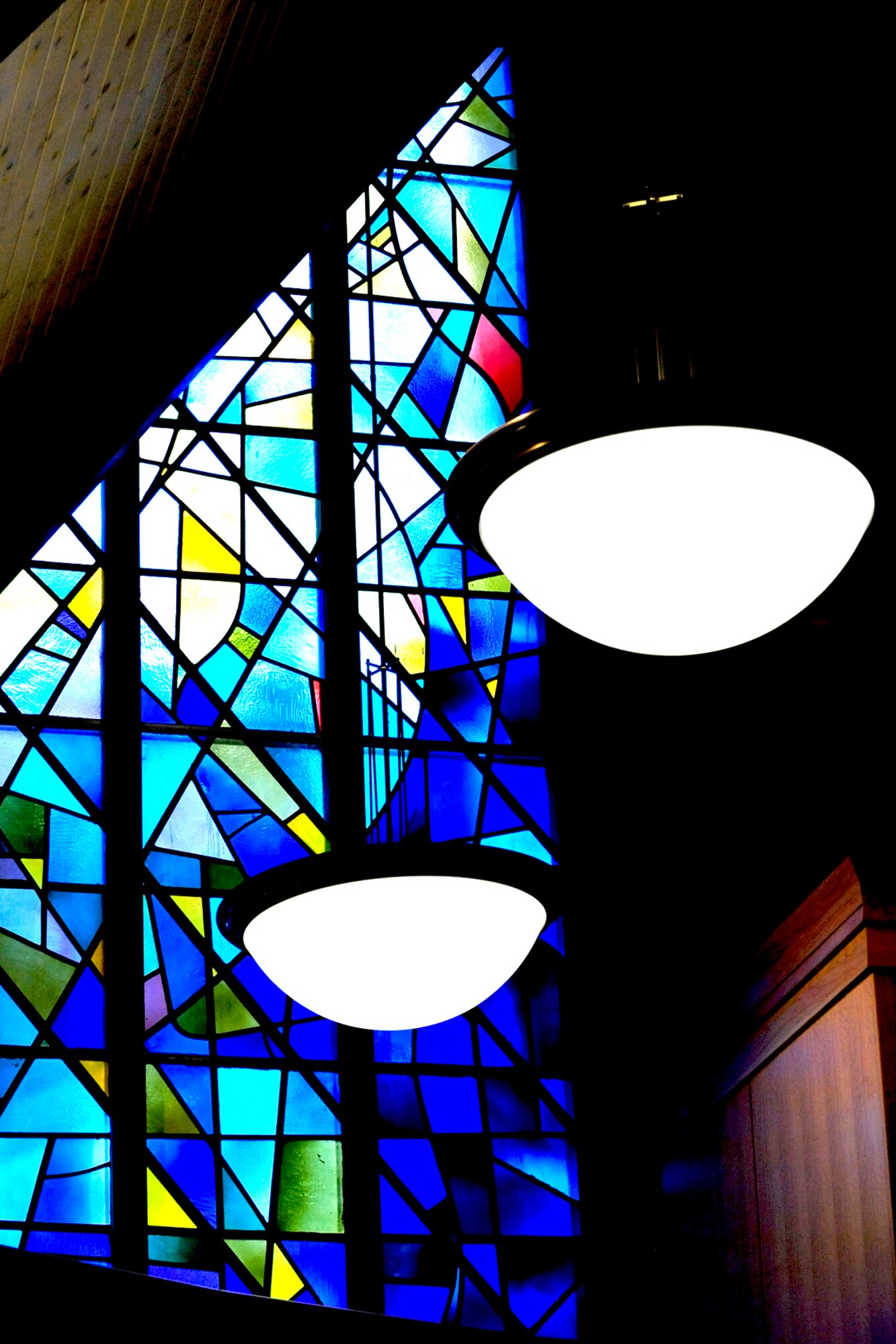 The stained glass windows form a decided contrasts to the light oak paneling and trim. (Air Force photo by: Kim Cook)