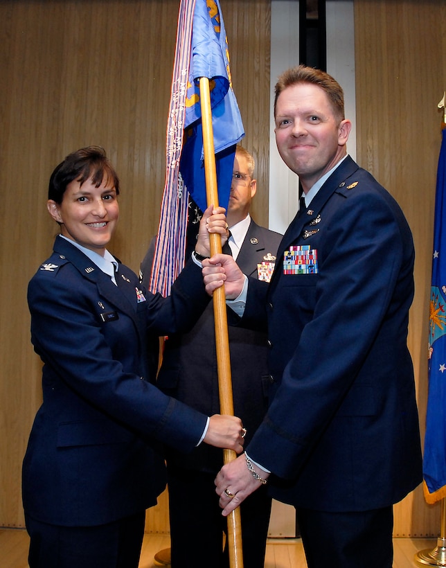 Maj. Wade Dillard (right), takes command of the 82nd Communications Squadron July 16, during an assumption of command ceremony in the auditorium of Bldg. 1900 at Sheppard Air Force Base, Texas. Col. Kimberley Ramos (left), 82nd Mission Support Group commander, officiated the ceremony. Major Dillard attended the Air Command and Staff College at Maxwell AFB, Ala., prior to arriving at Sheppard. (U.S. Air Force photo/Michael Litteken)