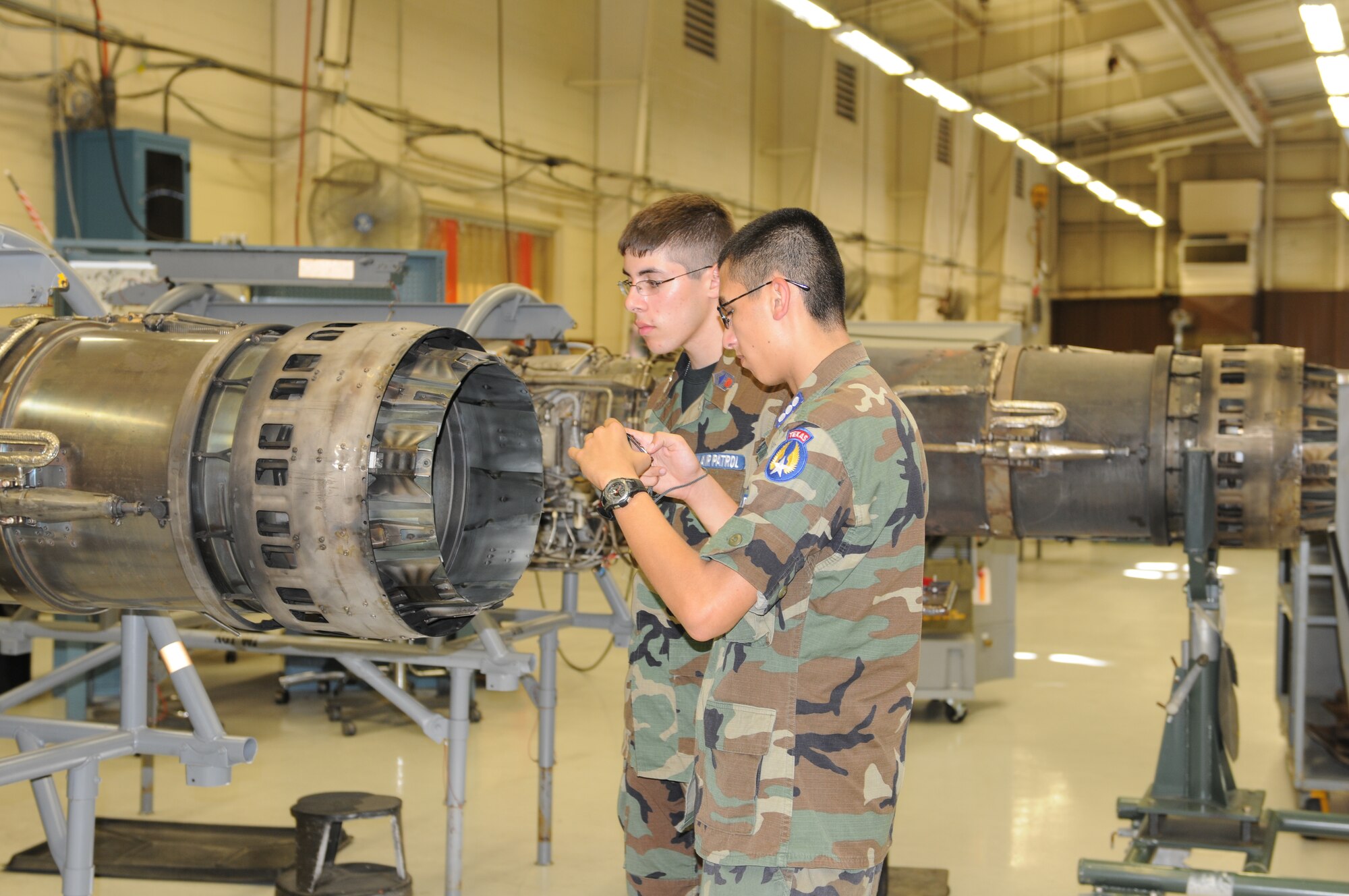 CAP cadets look at a T-38 Talon engine during their tour of DynCorp Maintenance Facility while participating in the CAP SUPTFC program July 12-16. (U.S. Air Force photo/Elizabeth Owens).