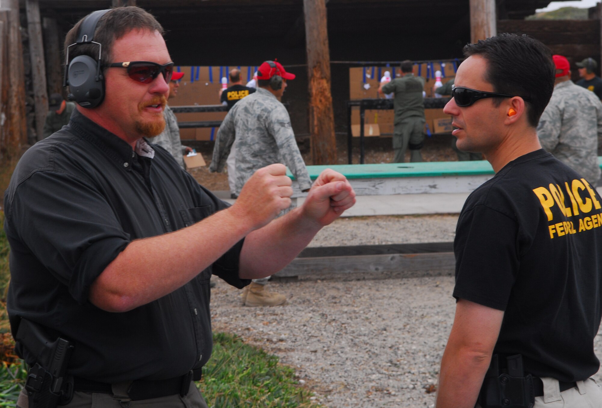 VANDENBERG AIR FORCE BASE, Calif. – Jay Prichard, curator of the Vandenberg Heritage Center, speaks with Special Agent Wil Thompson, the Air Force Office of Special Investigations, Detachment 804 commander, at the Vandenberg OSI's 3rd Annual Bowling Pin Shoot at the Rod and Gun Club here Friday, July 23, 2010. The objective of the competition, for the competitors, was to race against the clock, and one another, to knock standard bowling pins clear off of a table in the shortest amount of time with a handgun. (U.S. Air Force photo/Senior Airman Steve Bauer)

