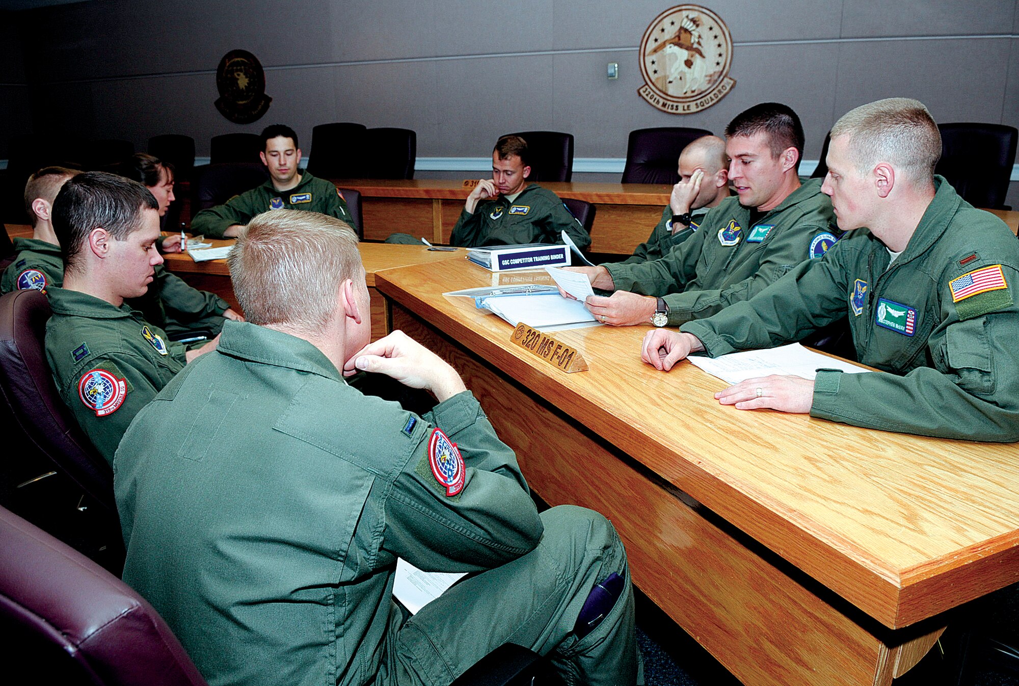 Global Strike Challenge team members introduce themselves to Capt.
Nathan Bischoping, 90th Operations Support Squadron, during a team
introduction meeting July 12. The team members are Capt. Dylan Monaghan and
1st Lt. Frank Timothy, from the 319th Missile Squadron; 2nd Lt. Stephen
McVay and 1st Lt. Daniel Moore, from the 321st Missile Squadron; 1st Lt.
David Bull and 1st Lt. Jonathan Elsner, from the 320th Missile Squadron;
along with the alternate team of 1st Lt. Jacob Lusson, 320th MS, and 1st Lt.
Jessica Stuffel, 321st MS. (U.S. Air Force photo by Gerald Teano)