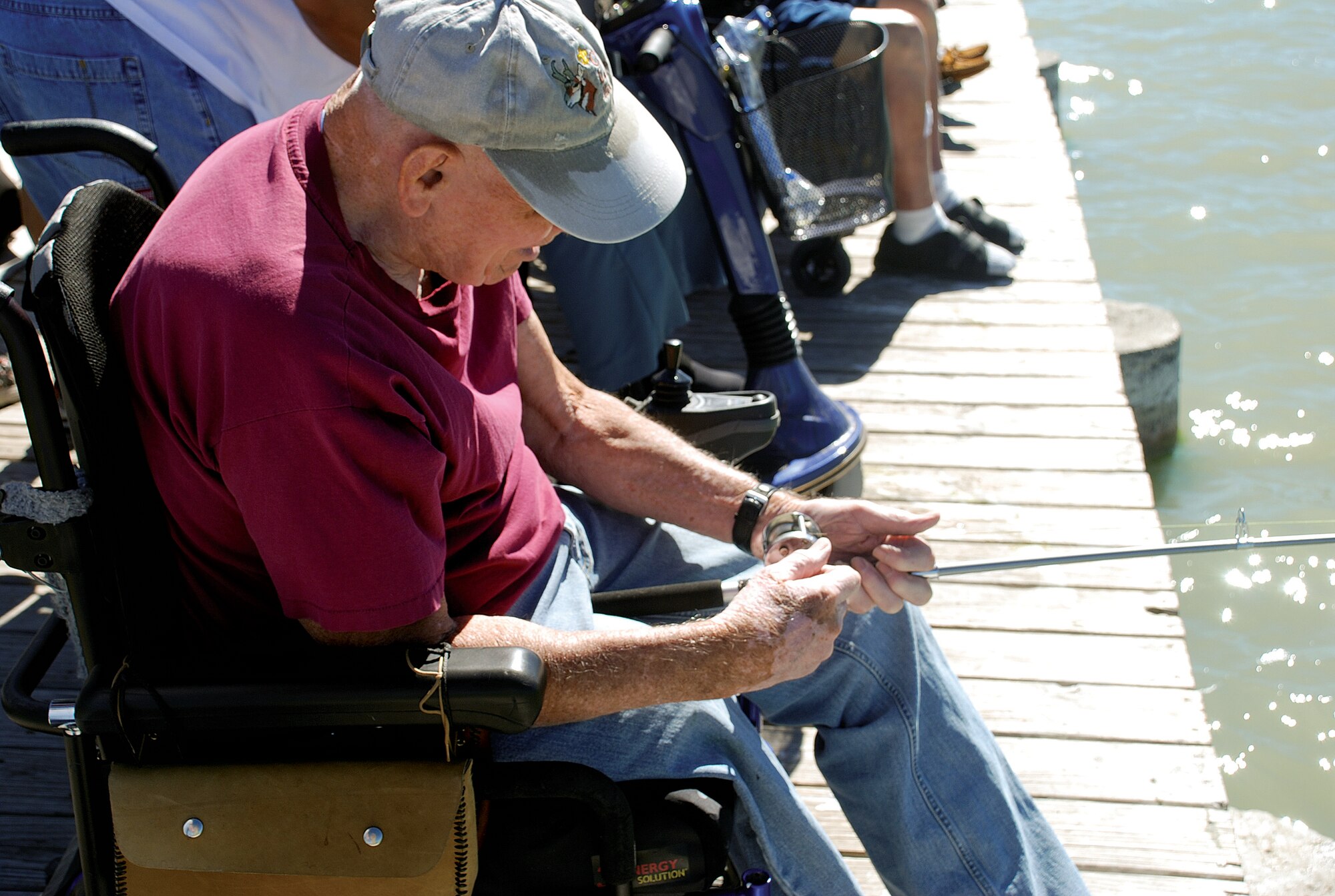 Retired veteran Jim Paxton reels in his line. during the fishing day July 16. (U.S. Air Force photo by Staff Sgt. Mike Tryon)