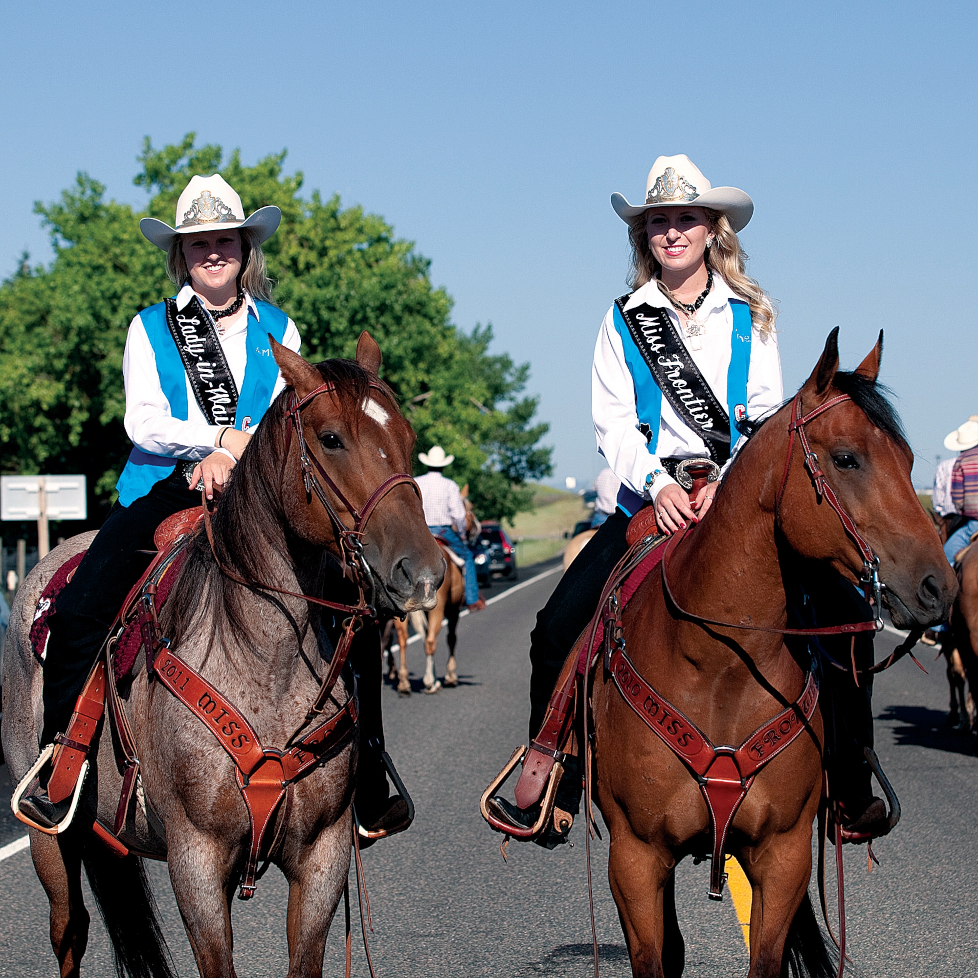 Rachel Shutter, Miss Frontier, and Amy Berry, her Lady in Waiting, sit on their horses during the cattle drive July 19. The cattle drive has been a CFD tradition for more than 70 years. (U.S. Air Force photo by Jeff Allred)