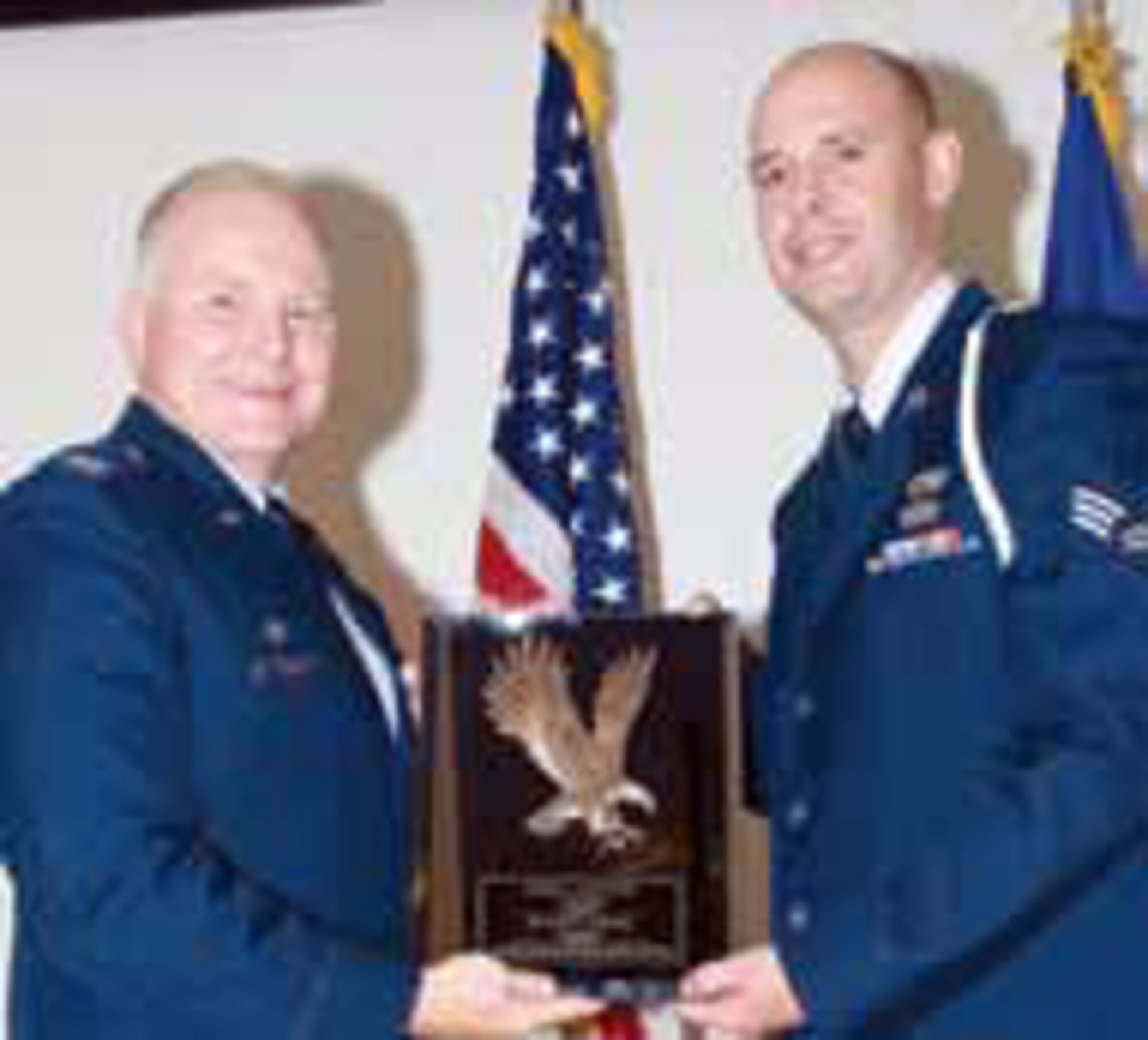 Two Airmen won top honors during the graduation ceremony at Edwards AFB Airman Leadership School. Senior Airman Eric Liberty, 50th Aerial Port Sq., accepts the honor graduate John Levitow Award from Col. Jerry Gandy. Chief Master Sgt. Agustin Huerta, 452 AMW command chief,  said Edwards ALS doesn’t have record of any Reserve Airman who has earned this prestigious award in the past. (U. S. Air Force photo)
