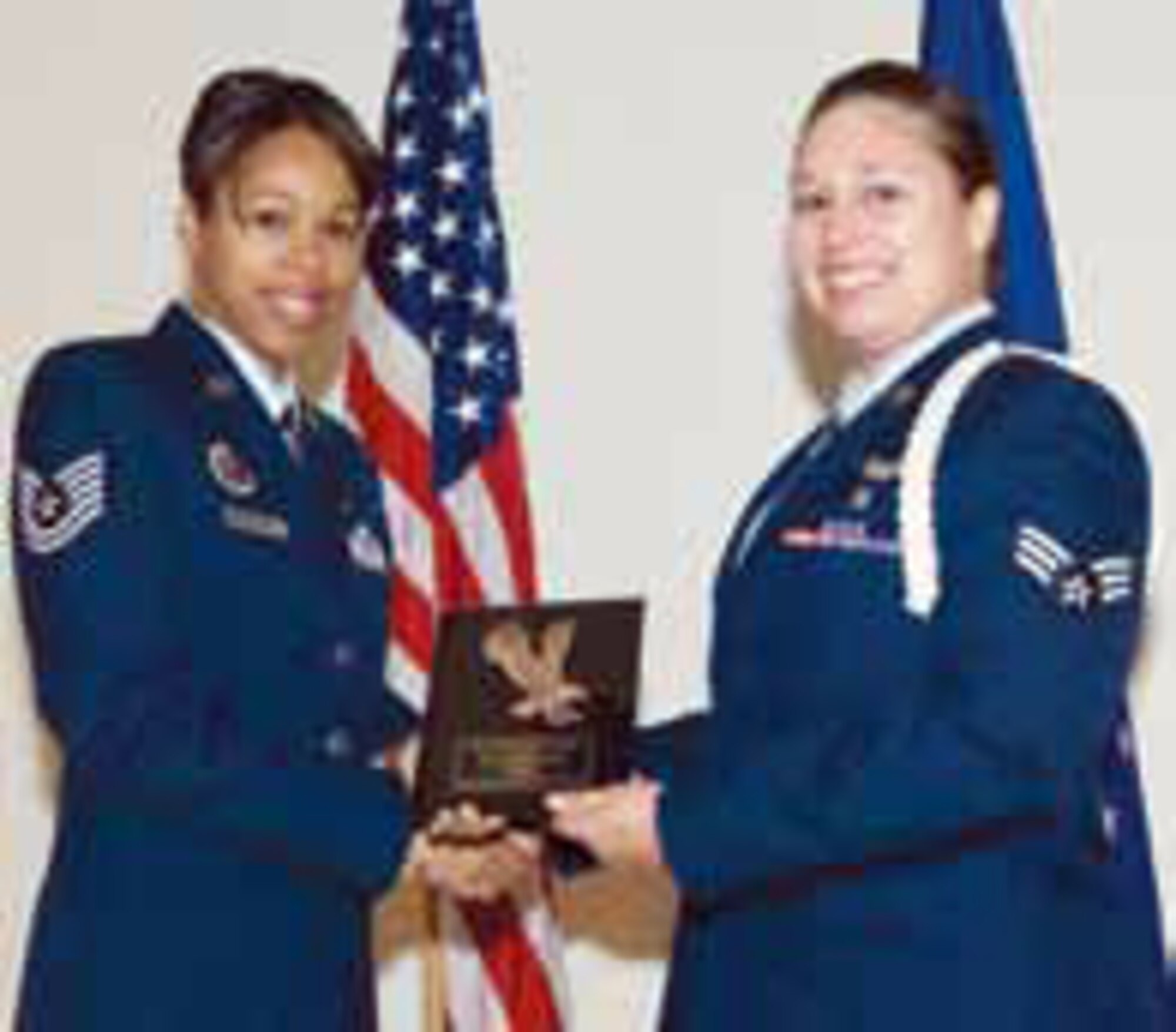 Two Airmen won top honors during the graduation ceremony at Edwards AFB Airman Leadership School. Senior Airman Kambree Moses, 452nd Aeromedical Evacuation Sq., accepts the Leadership Award from Tech. Sgt. Lauren Davidson. Chief Master Sgt. Agustin Huerta, 452 AMW command chief, said Edwards ALS doesn’t have record of any Reserve Airman who has earned this prestigious award in the past. (U.S. Air Force photo)
