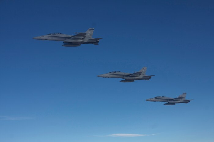 NELLIS AIR FORCE BASE, Nev. -- U.S. Marine Corps F-18s from Marine Attack Squadron 225, Marine Corps Air Station Miramar, Calif., Fly in formation over the Nevada Test and Training Range during Red Flag-Nellis 10-4 mission July 21, 2010. Red Flag is a realistic combat training exercise involving the air forces of the United States and its allies. The exercise is hosted north of Las Vegas on the Nevada Test and Training Range--the U.S. Air Force's premier military training area with more than 12,000 square miles of airspace and 2.9 million acres of land. With 1,900 possible targets, realistic threat systems and an opposing enemy force that cannot be replicated anywhere else in the world, Nellis and the NTTR are the home of a "peacetime battlefield," providing combat air forces with the ability to train to fly, fight and win together. (U.S. Navy photo by Petty Officer 1st Class Stephen Wolff)