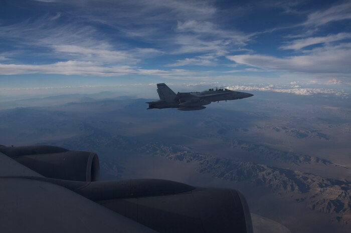 NELLIS AIR FORCE BASE, Nev. -- A U.S. Marine Corps F-18 from Marine Attack Squadron 225, Marine Corps Air Station Miramar, Calif., waits to refuel in the skies over the Nevada Test and Training Range during Red Flag-Nellis 10-4 mission July 21, 2010. Red Flag is a realistic combat training exercise involving the air forces of the United States and its allies. The exercise is hosted north of Las Vegas on the Nevada Test and Training Range--the U.S. Air Force's premier military training area with more than 12,000 square miles of airspace and 2.9 million acres of land. With 1,900 possible targets, realistic threat systems and an opposing enemy force that cannot be replicated anywhere else in the world, Nellis and the NTTR are the home of a "peacetime battlefield," providing combat air forces with the ability to train to fly, fight and win together. (U.S. Navy photo by Petty Officer 1st Class Stephen Wolff)