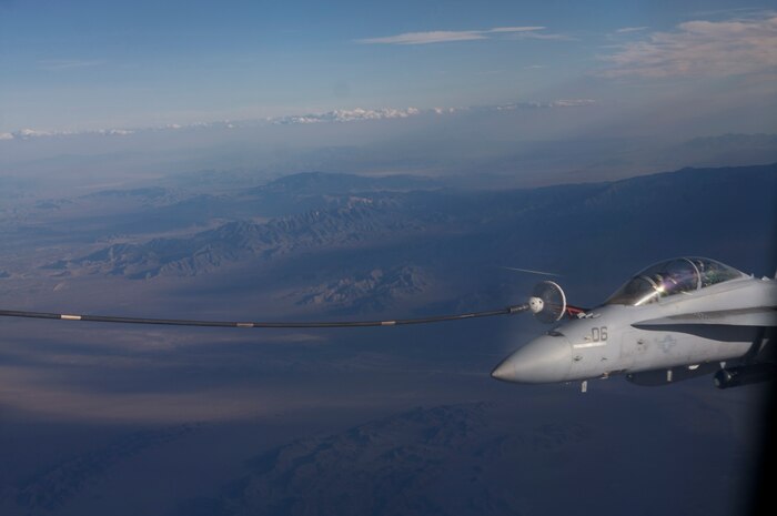 NELLIS AIR FORCE BASE, Nev. -- A U.S. Marine Corps F-18 from Marine Attack Squadron 225, Marine Corps Air Station Miramar, Calif., refuels in the skies over the Nevada Test and Training Range during Red Flag-Nellis 10-4 mission July 21, 2010. Red Flag is a realistic combat training exercise involving the air forces of the United States and its allies. The exercise is hosted north of Las Vegas on the Nevada Test and Training Range--the U.S. Air Force's premier military training area with more than 12,000 square miles of airspace and 2.9 million acres of land. With 1,900 possible targets, realistic threat systems and an opposing enemy force that cannot be replicated anywhere else in the world, Nellis and the NTTR are the home of a "peacetime battlefield," providing combat air forces with the ability to train to fly, fight and win together. (U.S. Navy photo by Petty Officer 1st Class Stephen Wolff)