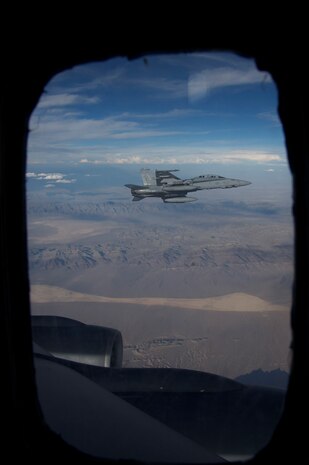 NELLIS AIR FORCE BASE, Nev. --  A U.S. Marine Corps F-18 from Marine Attack Squadron 225, Marine Corps Air Station Miramar, Calif., waits to refuel in the skies over the Nevada Test and Training Range during Red Flag-Nellis 10-4 mission July 21, 2010. Red Flag is a realistic combat training exercise involving the air forces of the United States and its allies. The exercise is hosted north of Las Vegas on the Nevada Test and Training Range--the U.S. Air Force's premier military training area with more than 12,000 square miles of airspace and 2.9 million acres of land. With 1,900 possible targets, realistic threat systems and an opposing enemy force that cannot be replicated anywhere else in the world, Nellis and the NTTR are the home of a "peacetime battlefield," providing combat air forces with the ability to train to fly, fight and win together. (U.S. Navy photo by Petty Officer 1st Class Stephen Wolff)