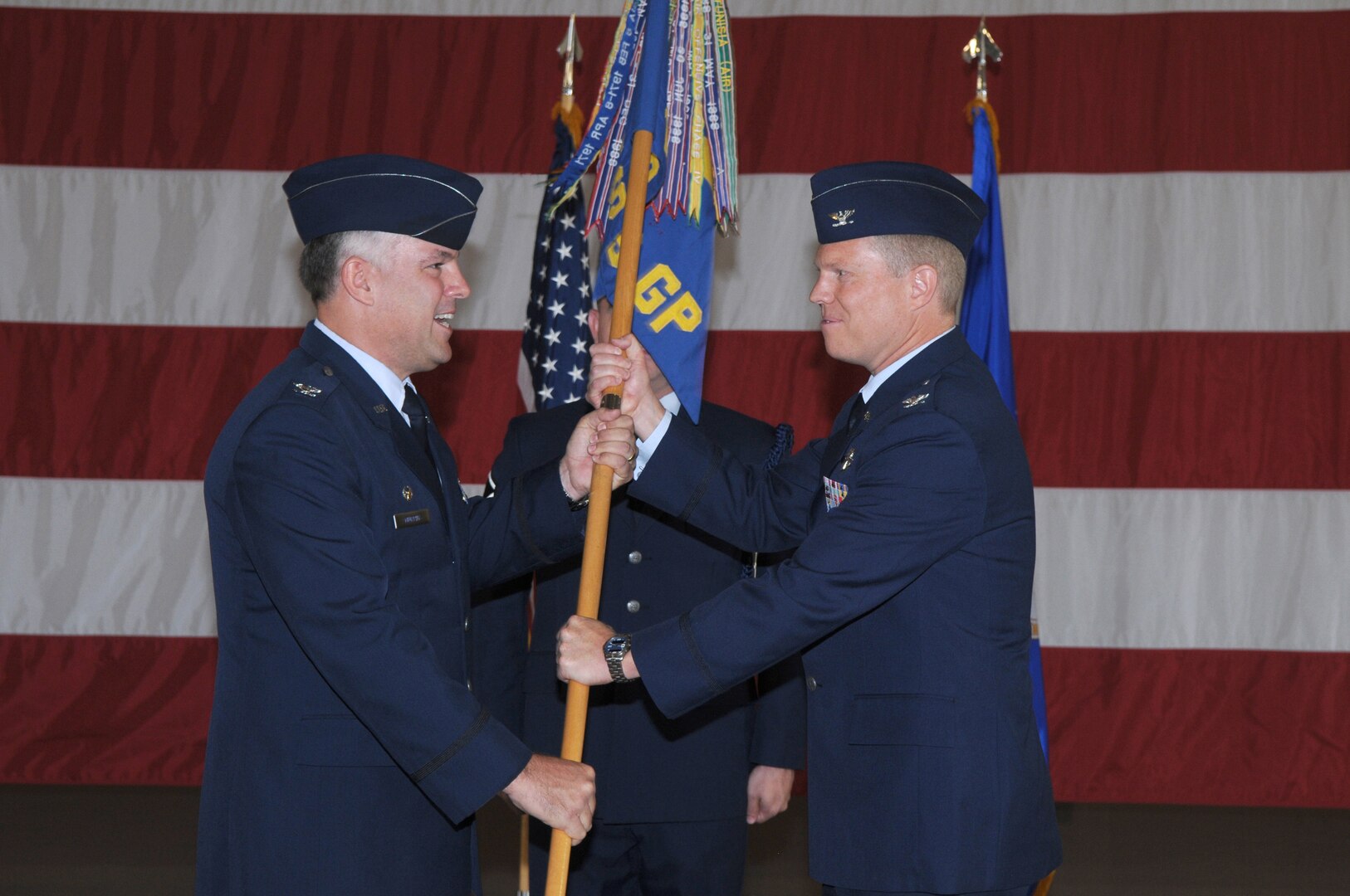 Col. Richard Murphy (left),12th Flying Training Wing commander, passes the guidon to Col. Andrew Croft (right) as he assumes command of the 12th Operations Group at Randolph Air Force Base July 23. (U.S. Air Force photo/Rich McFadden)