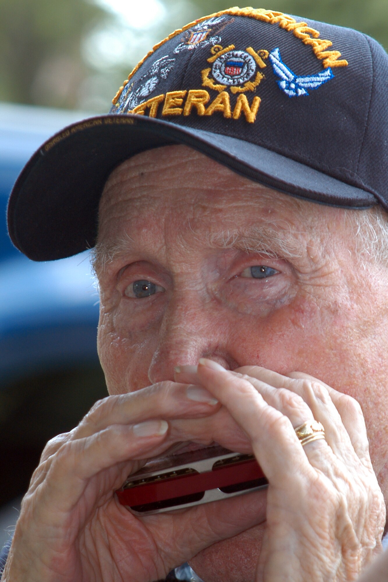 GRISSOM AIR RESERVE BASE, Ind., -- Ike Tharp, a World War II veteran from Kokomo, plays the Air Force song on the harmonica to conclude the  "Voices of History" presentations during a luncheon held in the Grissom Aeroplex July 21. The luncheon allowed Grissom Airmen an opportunity to interact with local World War II veterans as well as a member of the famed Tuskegee Airmen. (U.S. Air Force photo/Tech. Sgt. Douglas Hays)