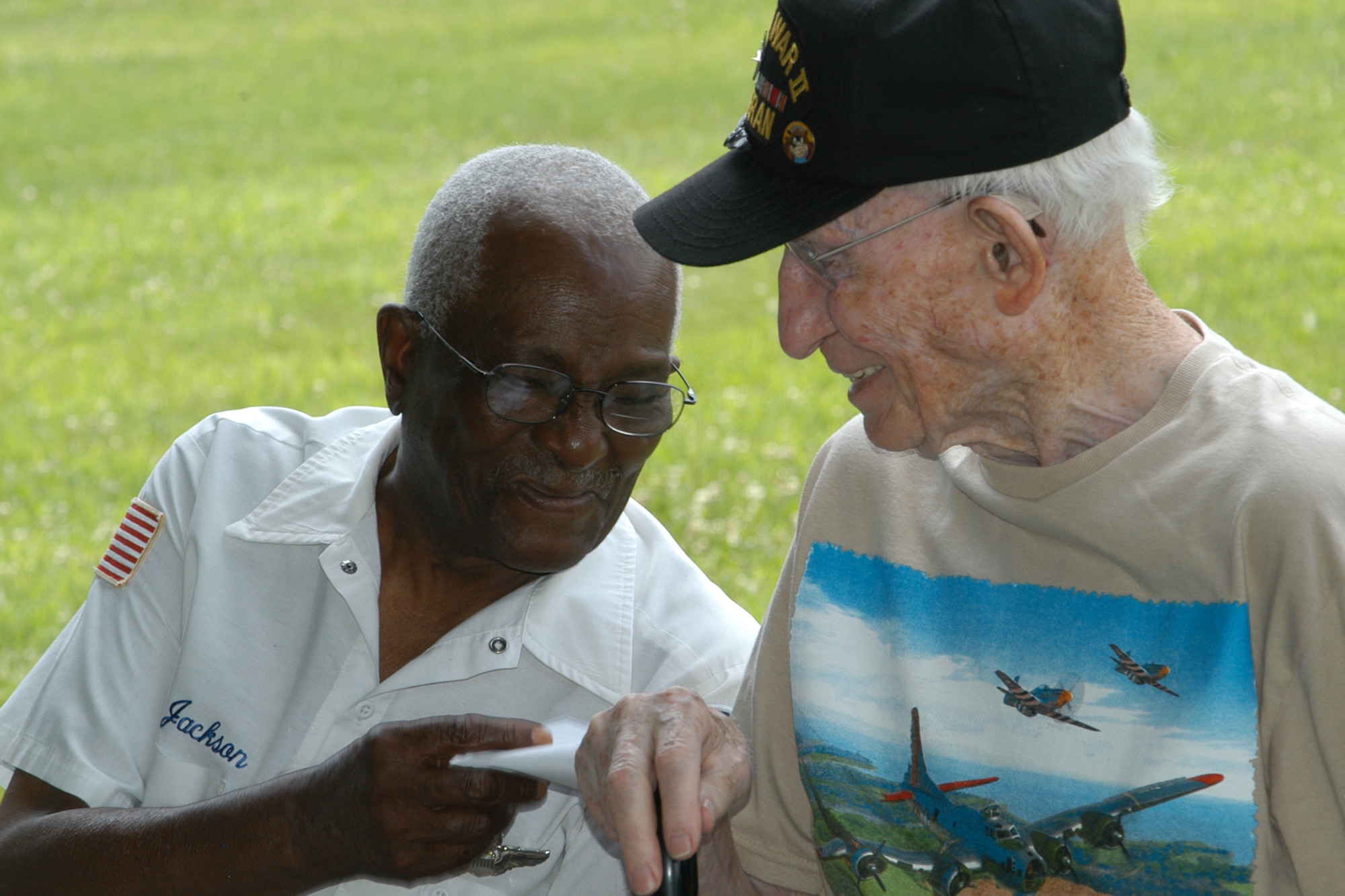GRISSOM AIR RESERVE BASE, Ind., -- Julius Jackson, left, and Charles Ormsby, share a laugh during a 'Voices of History' luncheon held in the Grissom Aeroplex July 21st. Jackson, a member of the Tuskegee Airman, and Ormsby, a B-17 member with the 398th Bomb Group, spoke to Grissom Airmen and other veterans, sharing their experience as aviators during World War II. (U.S. Air Force photo/Tech. Sgt. Douglas Hays)