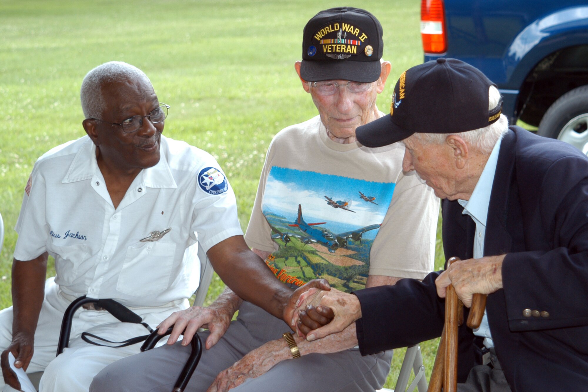 GRISSOM AIR RESERVE BASE, Ind., --Lt. Col. Julius Jackson, left, greets Ike Tharp of Kokomo, right as Charles Ormsby watches on, during a special gathering July 21st in the Grissom Aeroplex. Colonel Jackson was a member of the famed Tuskegee Airmen, while Ormbsby ws an aerial engineer and gunner on a B-17 in World War II. Mr. Tharp, also a veteran played the Air Force song on the harmonica during the event. (U.S. Air Force photo/Tech. Sgt. Doug Hays)