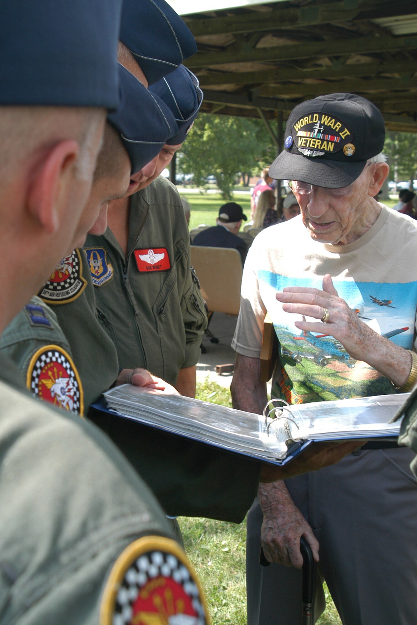 GRISSOM AIR RESERVE BASE, Ind., -- Charles Ormsby, a retired aerial engineer/gunner on the B-17, shows a scrapbook to members of the 74th Air Refueling Squadron, during a special outing held in the Grissom Aeroplex July 21. The program, entitled 'Voices of History' brought several World War II aviators in to speak with Grissom Airmen. (U.S. Air Force photo/Tech. Sgt. Doug Hays)