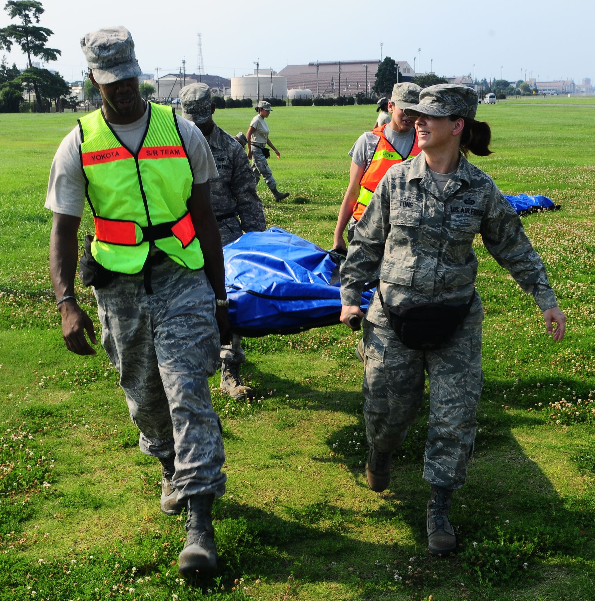 YOKOTA AIR BASE, Japan -- Airmen participating in the Search and Recovery Core Team Training carry a simulated body to a van July 22. The findings are sent away to Dover Air Force Base, Delaware to be handled properly. (U.S. Air Force photo/Airman 1st Class Sean Martin)