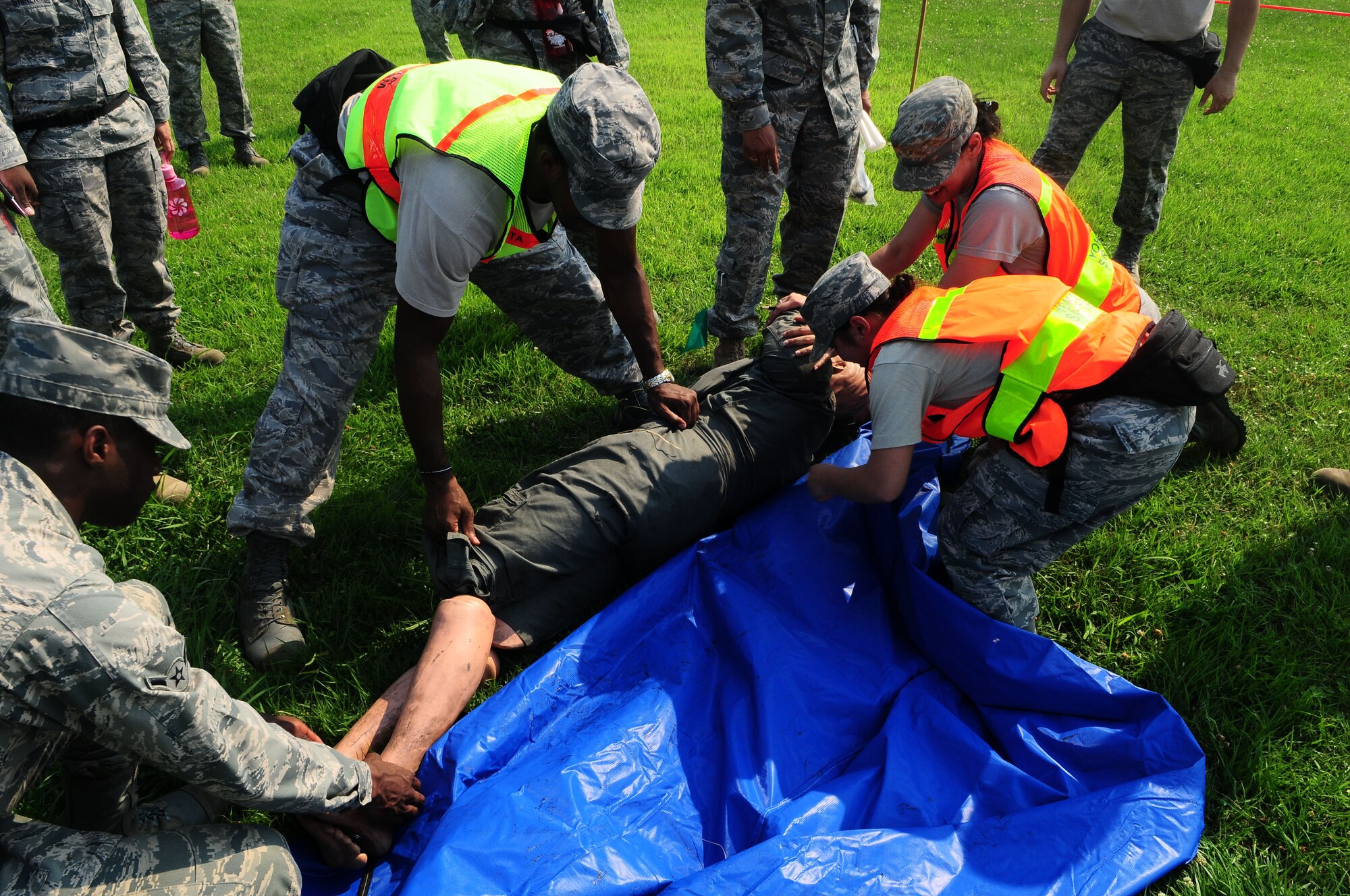 YOKOTA AIR BASE, Japan -- Airmen that participated in the Search and Recovery Core Team Training bag up a simulated casualty July 22. The S&R team is responsible for cleaning up body parts and equipment at a crah site. (U.S. Air Force photo/Airman 1st Class Sean Martin)