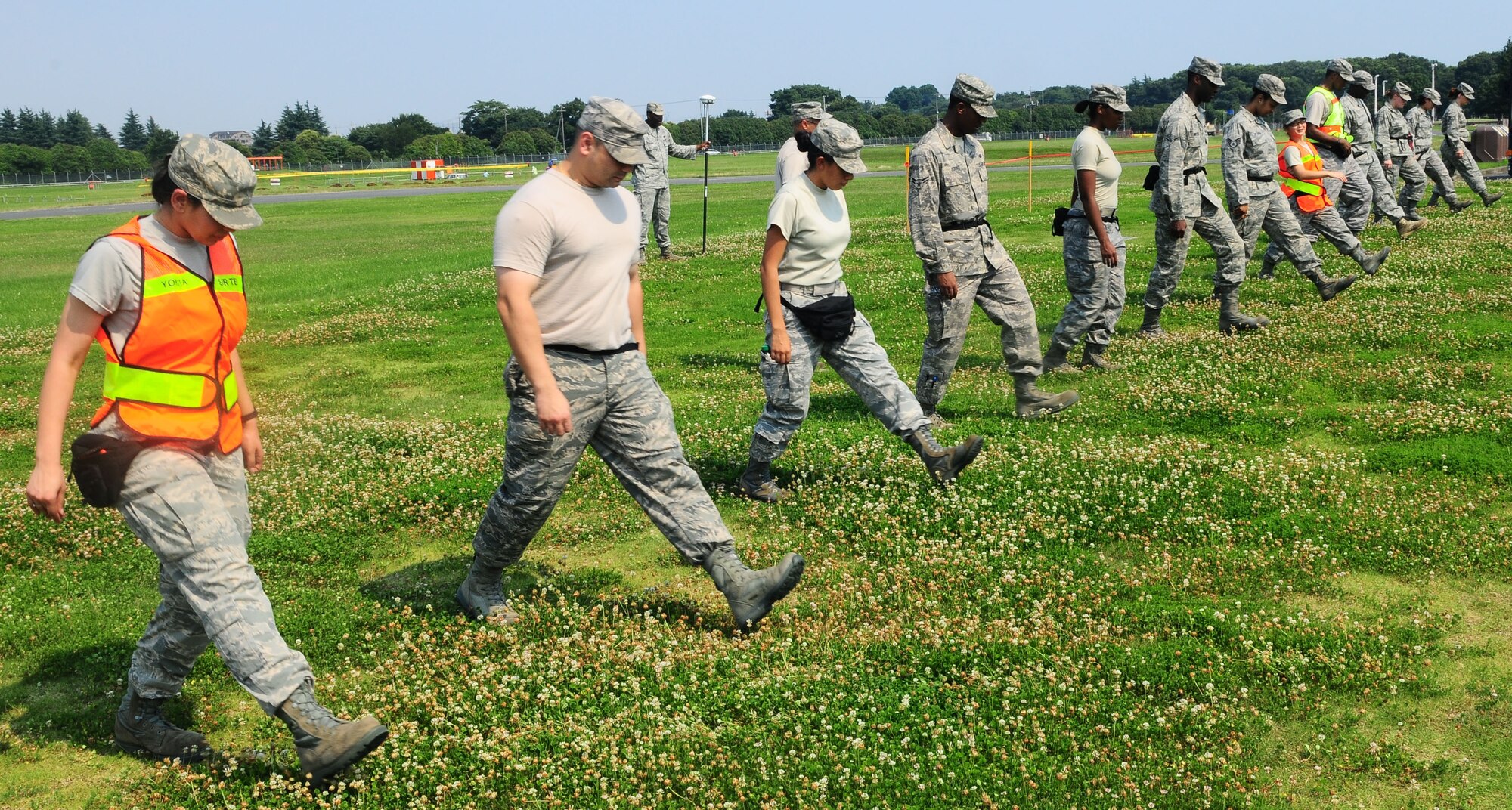 YOKOTA AIR BASE, Japan -- Airmen participating in the Search and Recovery Core Team Training perform a sweep of the simulated crash site July 22. (U.S. Air Force photo/Airman 1st Class Sean Martin)