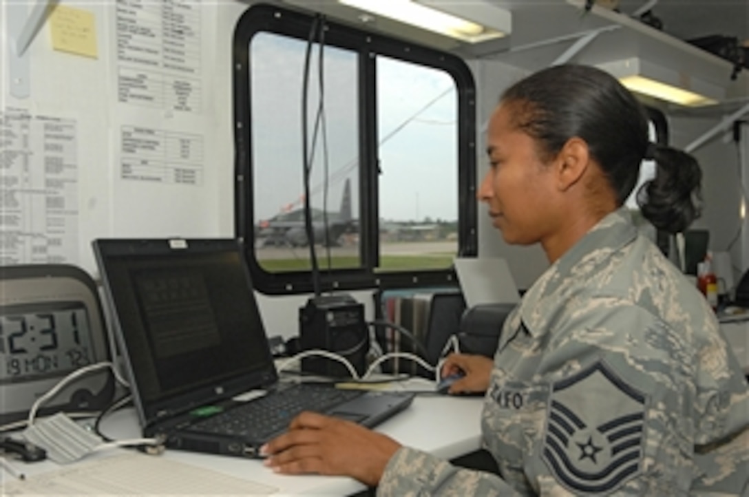 U.S. Air Force Master Sgt. Alicia Gilbert, with an airlift control flight, coordinates and schedules military airlift operations at Bush Field in Augusta, Ga., in support of Global Medic 2010 on July 19, 2010.  Global Medic, a joint field training exercise for theater aeromedical evacuation system and ground medical components, replicates all aspects of combat medical service support.  