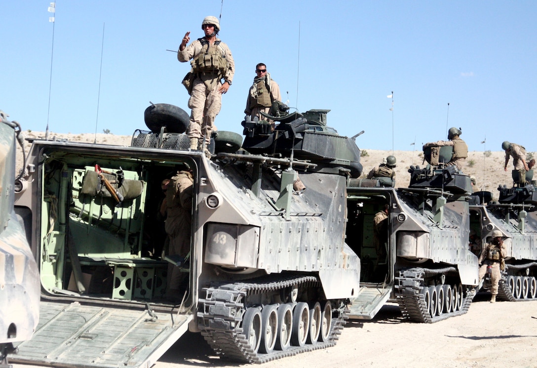 Marines with Kilo Company, 3rd Battalion, 5th Marine Regiment, unload from amphibious assault vehicles at Marine Corps Air Ground Combat Center Twentynine Palms, Calif., July 23 during exercise Enhanced Mojave Viper. Enhanced Mojave Viper prepared Marines for deployment to Afghanistan.