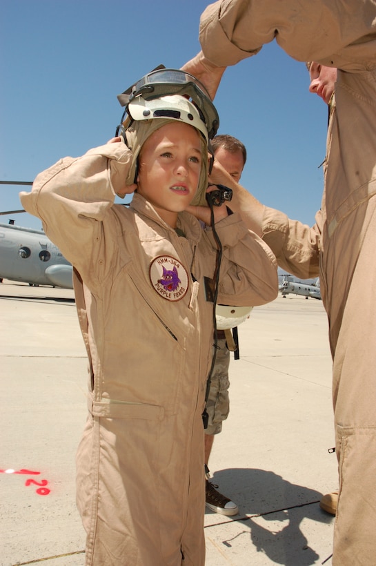 Eleven-year-old Riley Lamberson is properly fitted with a flight helmet during his visit with Marines from Marine Light Attack Helicopter Squadron 267 and Marine Medium Helicopter Squadron 364, both with the 3rd Marine Aircraft Wing. Riley, who has cystic fibrosis, spent the day with Marines at Marine Corps Base Camp Pendleton, Calif., July 23, as part of his wish with the Make-a-Wish Foundation.  (Official Marine Corps photos by Staff Sgt. Marc Ayalin)
