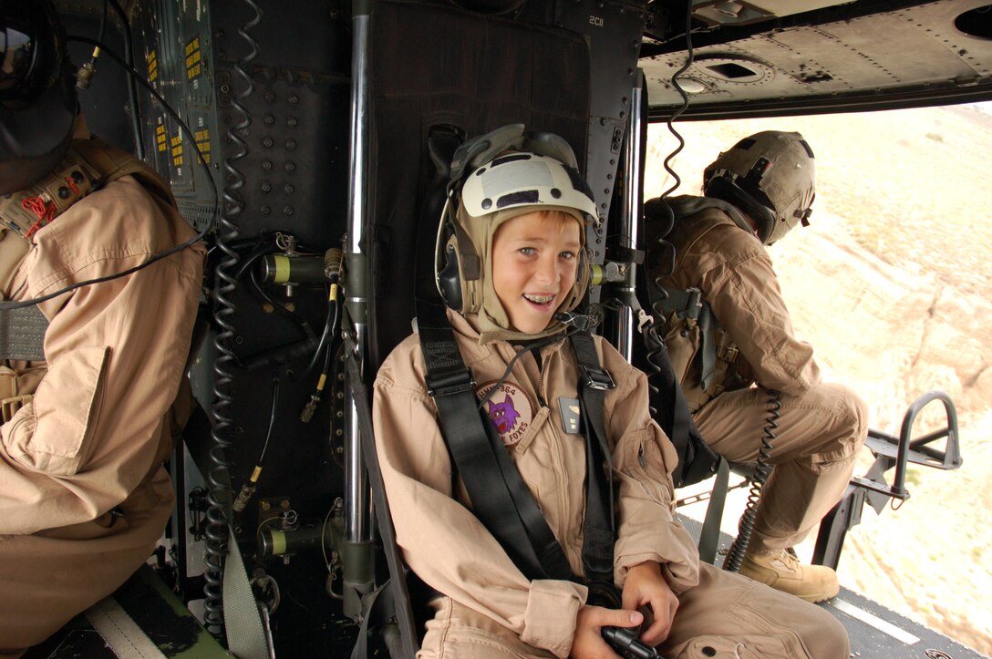 Eleven-year-old Riley Lamberson shows his excitement while flying in a UH-1Y Huey helicopter July 23, during his visit with Marines from Marine Light Attack Helicopter Squadron 267 and Marine Medium Helicopter Squadron 364, both with the 3rd Marine Aircraft Wing. Riley, who has cystic fibrosis, spent the day with Marines at Marine Corps Base Camp Pendleton, Calif., as part of his wish with the Make-a- Wish Foundation.  (Photo by Aaron Lamberson)