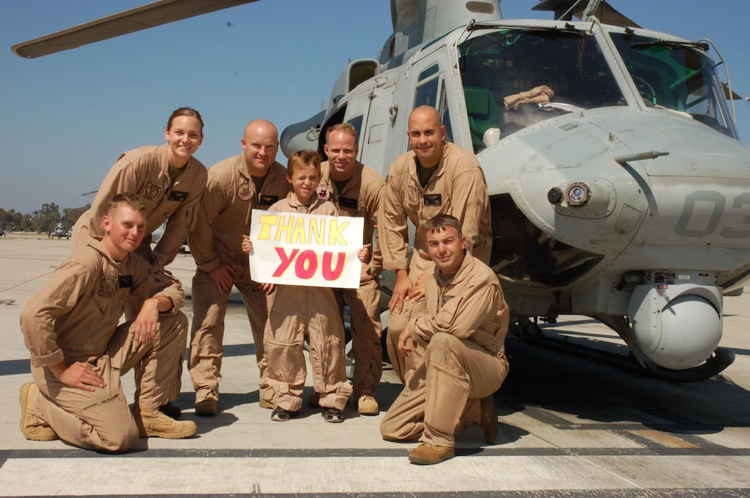 Eleven-year-old Riley Lamberson shows his gratitude with Marines from Marine Light Attack Helicopter Squadron 267 and Marine Medium Helicopter Squadron 364, both with the 3rd Marine Aircraft Wing July 23. Riley, who has cystic fibrosis, spent the day with Marines at Marine Corps Base Camp Pendleton, Calif., as part of his wish with the Make-a-Wish Foundation.  (Official Marine Corps photo by Staff Sgt. Marc Ayalin)
