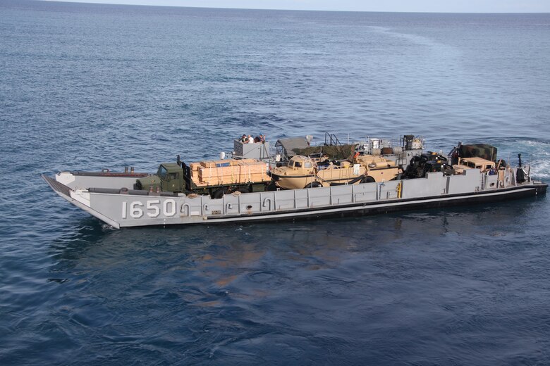 A Landing Craft Unit leaves the well deck of the USS Iwo Jima en route to Port-de-Paix, Haiti to deliver supplies ashore, July 24. USS Iwo Jima military personnel and non-government officials will provide Haiti with humanitarian civic assistance including medical, dental, veterinarian and engineering aid during Operation Continuing Promise 2010.
