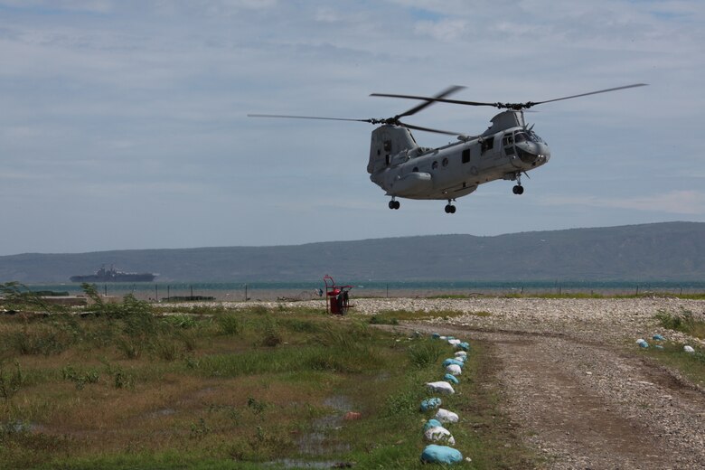 A CH-46E Sea Knight helicopter with Marine Medium Helicopter Squadron 774 lands on the shore of Port-de-Paix, Haiti, to offload military personnel from the USS Iwo Jima, July 24, 2010. Haiti is the first country visited for Continuing Promise 2010.  An operation designed to bring medical, dental, veterinary and engineering assistance to the area.
