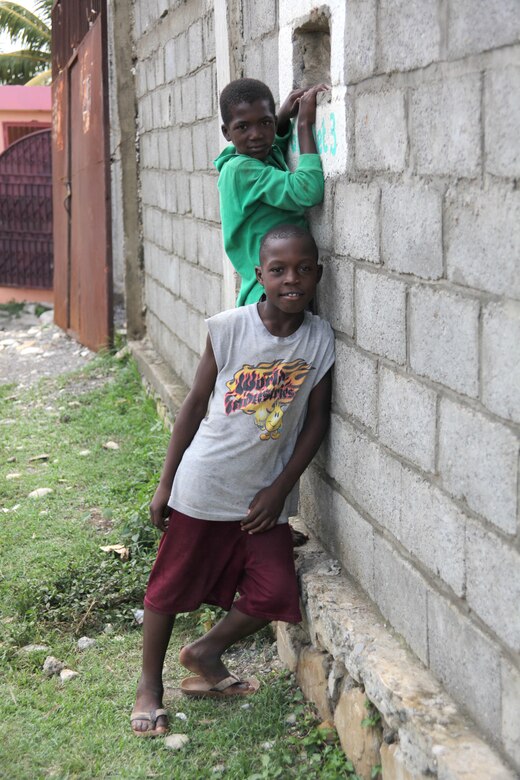 Two Haitians pose for a photo in Port-de-Paix, Haiti, July 24, 2010. Marines, Sailors, Soldiers, Airmen, foreign military and non-government officials will provide humanitarian civic support including medical, dental, veterinarian and engineering assistance as part of Operation Continuing Promise 2010.
