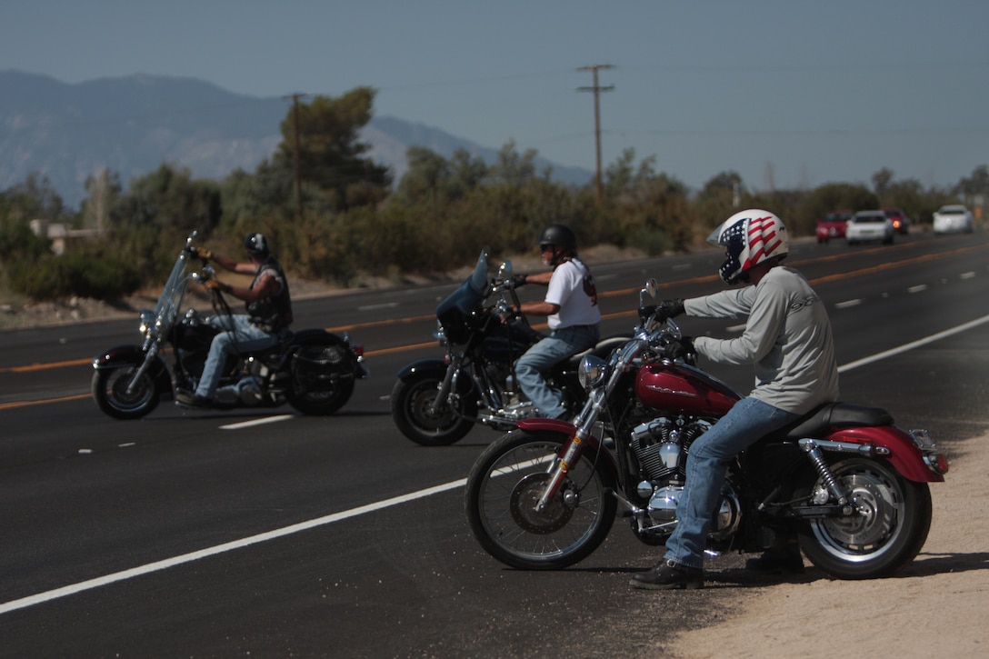 Bikers pull onto Highway 62 during the Phantom Fury Nomad Motorcycle Club's first Poker Run July 24, in hopes of raising money to build a trike for Staff Sgt. David Lyon, a member of the Wounded Warrior Regiment. Lyon was injured while conducting combat operations in support of Operation Enduring Freedom.