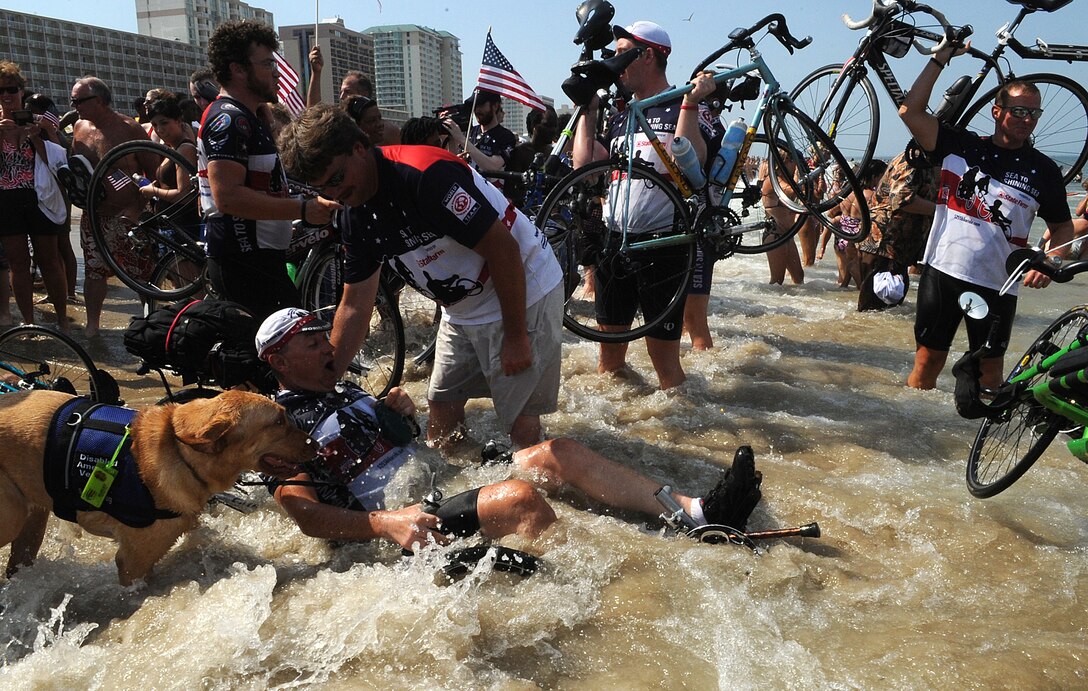 LANGLEY AIR FORCE BASE, Va. -- Riders celebrate in the Atlantic Ocean during the closing ceremony of Sea to Shining Sea at Virginia Beach July 24. Sea to Shining Sea is a 4000 mile bike ride which started at the Golden Gate Bridge and ended in Virginia Beach and includes injured military and a few able-bodied cyclists honoring the courage of our military and the strength of the American spirit.. (U.S. Air Force Photo/Staff Sgt. Christina M. Styer)