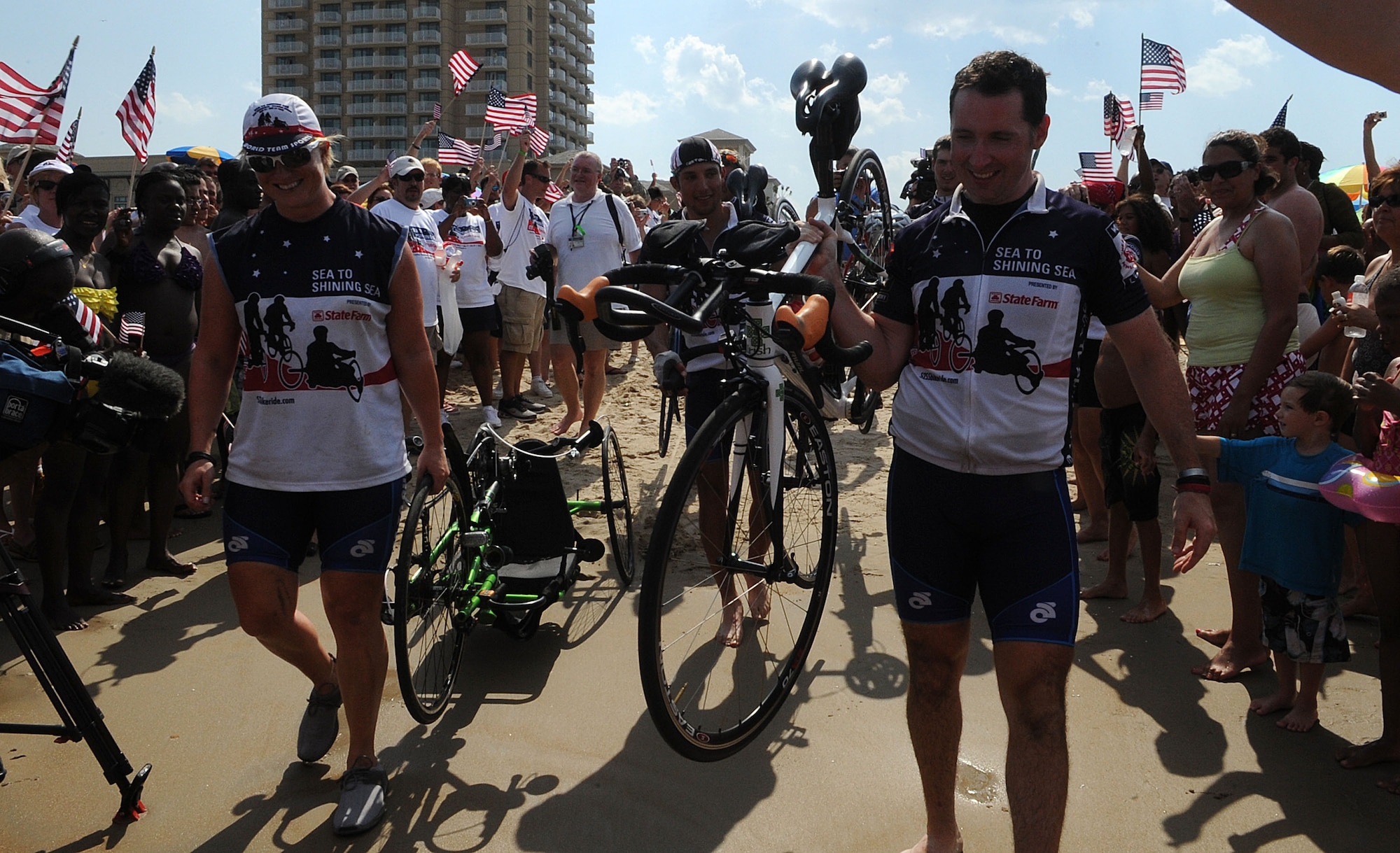 LANGLEY AIR FORCE BASE, Va. -- Riders make their way to the Atlantic Ocean during the closing ceremony of Sea to Shining Sea at Virginia Beach July 24. Sea to Shining Sea is a 4000 mile bike ride which started at the Golden Gate Bridge and ended in Virginia Beach and includes injured military and a few able-bodied cyclists honoring the courage of our military and the strength of the American spirit.. (U.S. Air Force Photo/Staff Sgt. Christina M. Styer)
