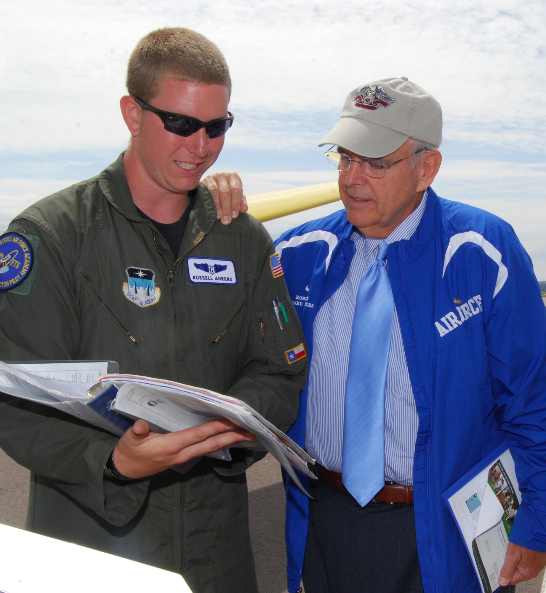 Cadet 2nd Class Russell Ahrens of Cadet Squadron 06 reviews a glider safety checklist with Robin Hayes during the Board of Visitors' tour of the Air Force Academy Airfield July 24, 2010. Mr. Hayes is a former North Carolina congressman and a current member of the BOV. Cadet Ahrens is an instructor pilot for the soaring program. (U.S. Air Force photo/Staff Sgt. Don Branum)