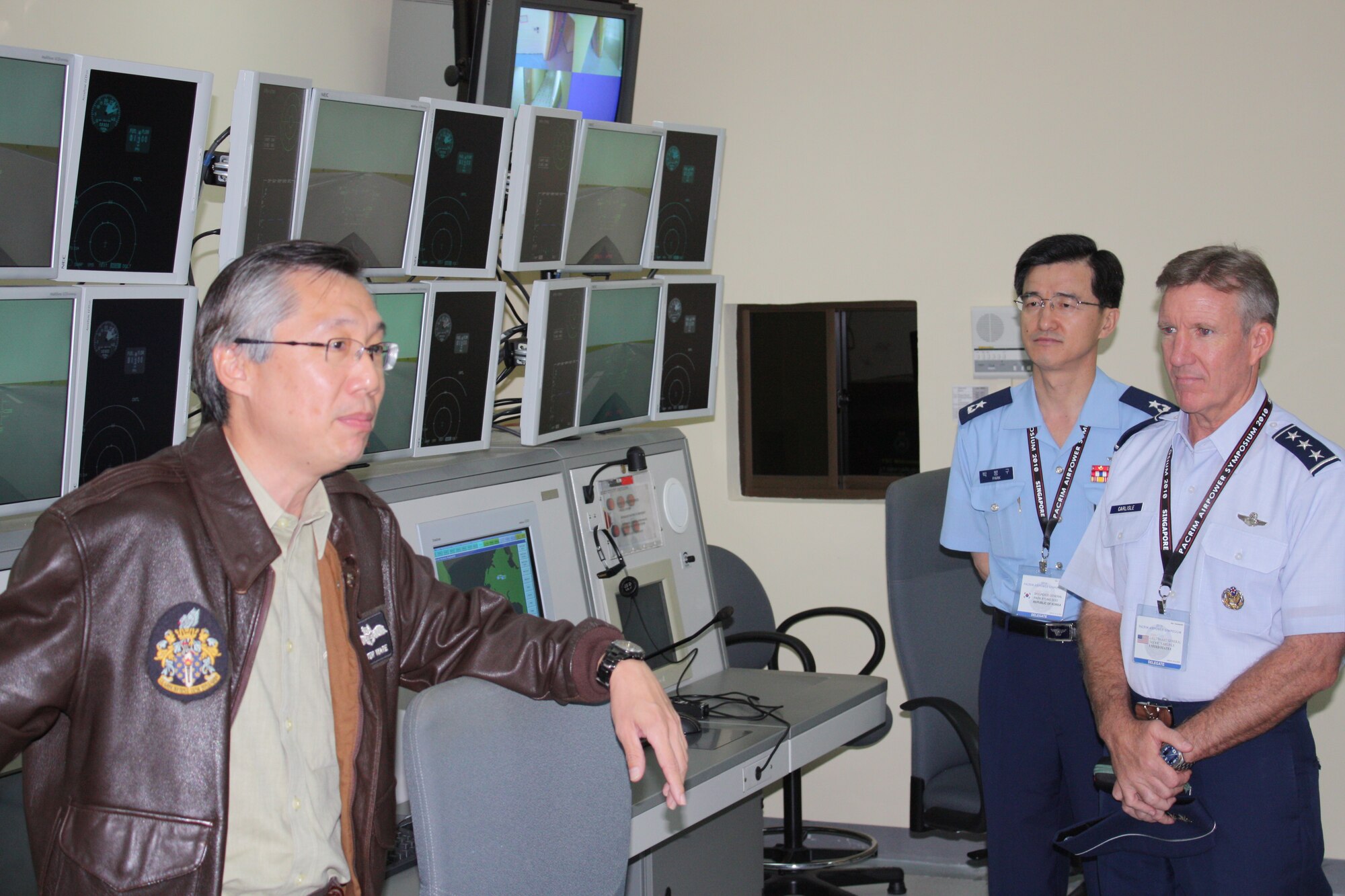 Lt. Gen. Hawk Carlisle, 13th Air Force commander, and Brig. Gen. Gyung Goo Park, Republic of Korea Air Force, during a tour of the Singapore Air Force’s flight simulator facility at Paya Lebar Air Base.  The tour was part of the PACRIM Airpower Symposium. The annual symposium encourages relationship building and enhances cooperation among the air forces of Asia-Pacific nations. This year's symposium theme, “The Role of Airpower in Peace Support Operations,” aims to help participants from 24 nations better understand how air forces can support peace-keeping missions in the region.  (U.S. Air Force photo/ Lt. Col. Ken Hoffman)