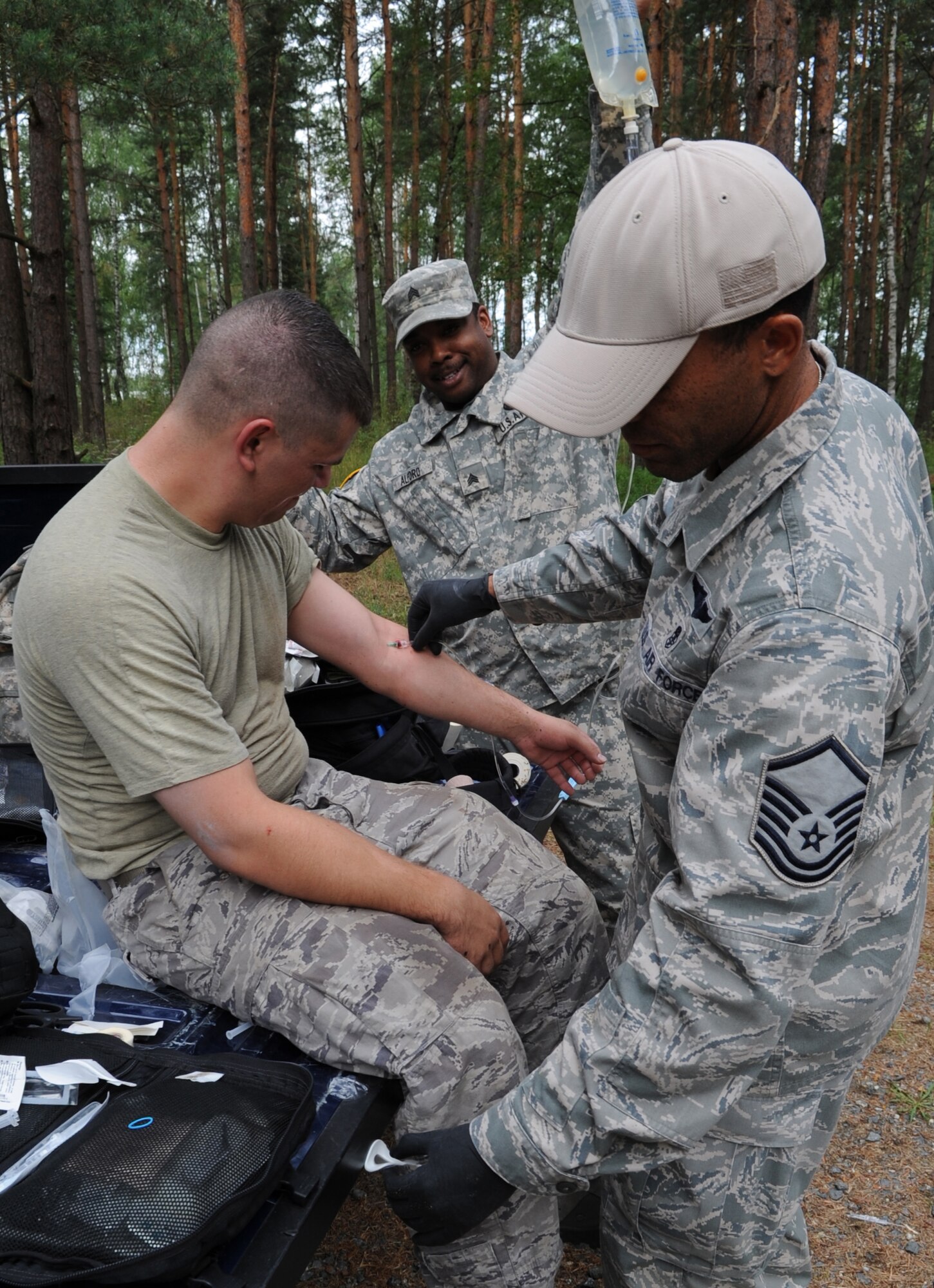 U.S. Air Force Master Sgt. Ronnie Wright, 435th Security Forces Squadron medic, Sembach Annex, Germany, and U.S. Army Sgt. Derrick Alford, Headquarters of Headquarters Company combat medic, Campbell Barracks, Heidelberg, Germany, provide medical care to Senior Airman Joshua Romero, 1st Air Support Operations Squadron radio maintenance, Army Garrison Wiesbaden, Germany, after completing an obstacle course during   Allied Strike 10, Grafenwoehr, Germany, July 23, 2010. ALLIED STRIKE is Europe's premier close air support (CAS) exercise, held annually to conduct robust, realistic CAS training that helps build partnership capacity among allied North Atlantic Treaty Organization nations and joint services while refining the latest operational CAS tactics. For more Allied Strike information go to www.usafe.af.mil/alliedstrike.asp. (U.S. Air Force photo by Senior Airman Caleb Pierce)