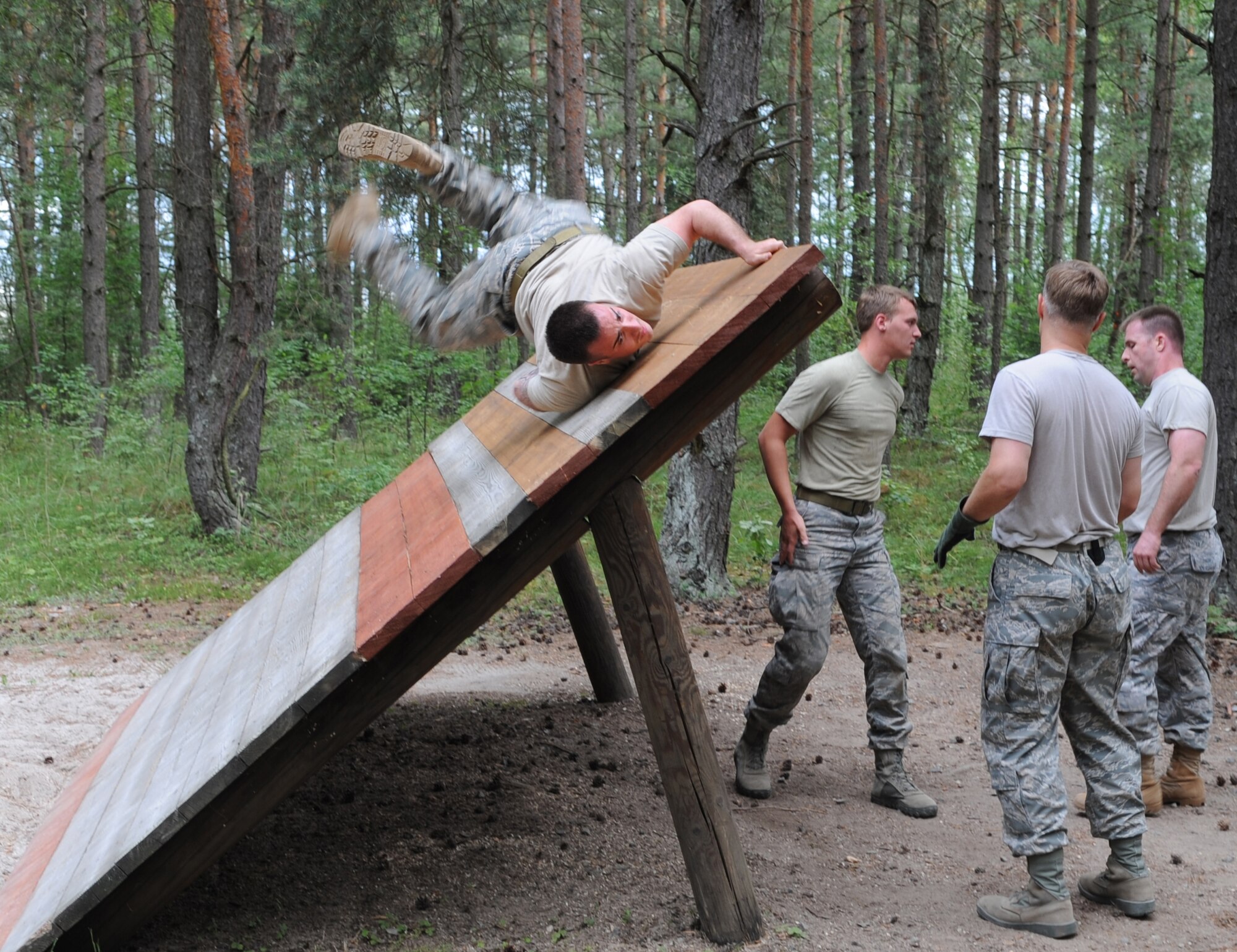 U.S. Air Force Airmen from the 8th Air Support Operations Squadron, Aviano Air Base, Italy, attempt to complete an obstacle during exercise Allied Strike 10, Grafenwoehr, Germany, July 23, 2010. Allied Strike is Europe's premier close air support (CAS) exercise, held annually to conduct robust, realistic CAS training that helps build partnership capacity among allied North Atlantic Treaty Organization nations and joint services while refining the latest operational CAS tactics. For more ALLIED STRIKE information go to www.usafe.af.mil/alliedstrike.asp. (U.S. Air Force photo by Senior Airman Caleb Pierce)
