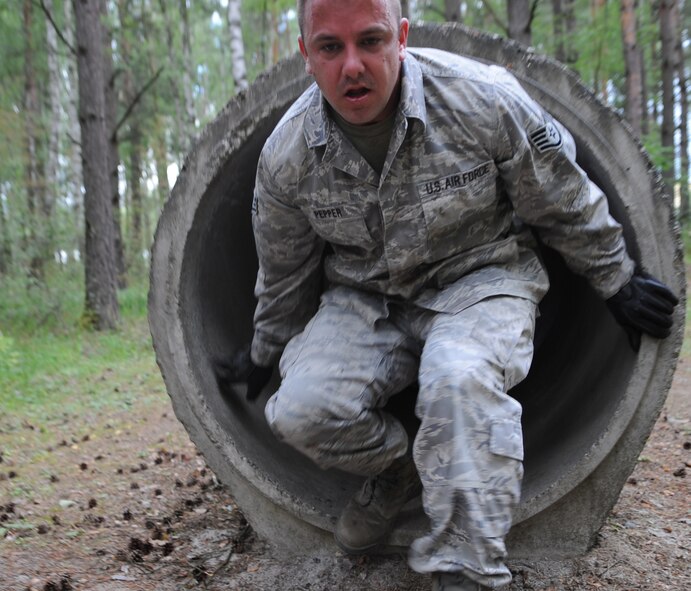 U.S. Air Force Staff Sgt. Robert Pepper, 4th Air Support Operations Squadron vehicle maintenance, Sullivan Barracks, Mannheim, Germany, completes an obstacle during Exercise Allied Strike 10, Grafenwoehr, Germany, July 23, 2010. Allied Strike is Europe's premier close air support (CAS) exercise, held annually to conduct robust, realistic CAS training that helps build partnership capacity among allied North Atlantic Treaty Organization nations and joint services while refining the latest operational CAS tactics. For more ALLIED STRIKE information go to www.usafe.af.mil/alliedstrike.asp. (U.S. Air Force photo by Senior Airman Caleb Pierce)