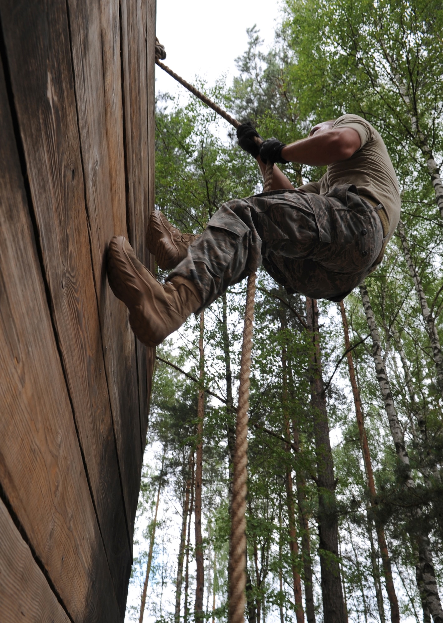 U.S. Air Force Staff Sgt. Till Schanz, 4th Air Support Operations Squadron power productions, Sullivan Barracks, Mannheim, Germany, attempts to complete an obstacle during exercise Allied Strike 10, Grafenwoehr, Germany, July 23, 2010. Allied Strike is Europe's premier close air support (CAS) exercise, held annually to conduct robust, realistic CAS training that helps build partnership capacity among allied North Atlantic Treaty Organization nations and joint services while refining the latest operational CAS tactics. For more ALLIED STRIKE information go to www.usafe.af.mil/alliedstrike.asp. (U.S. Air Force photo by Senior Airman Caleb Pierce)