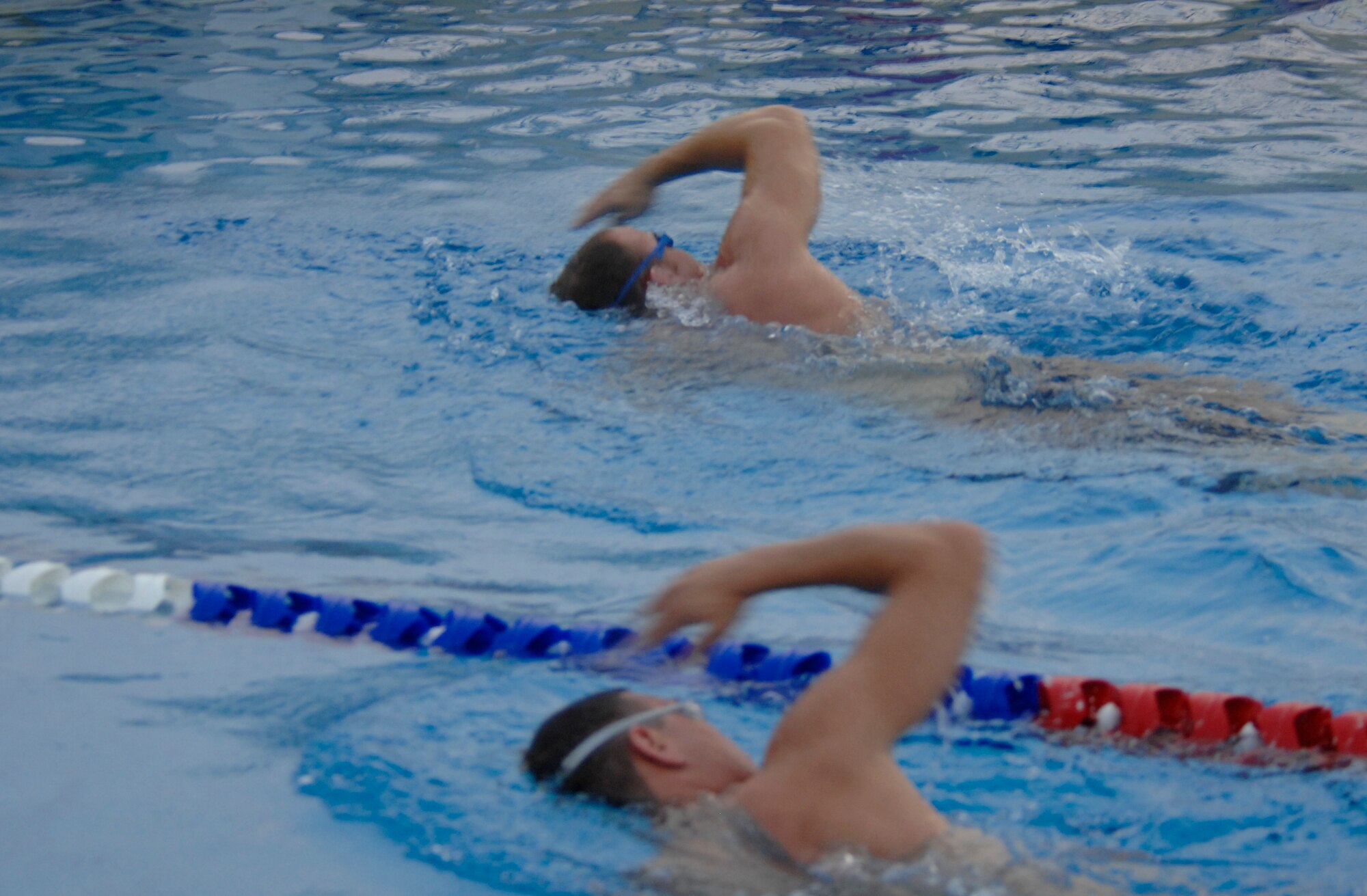 Two Airmen from the 380th Air Expeditionary Wing swim laps to warm up for
their CrossFit exercise session. Airmen often use time off in the deployed
environment to bolster their fitness levels. (U.S. Air Force Photo/SrA Bradley Kasch)
