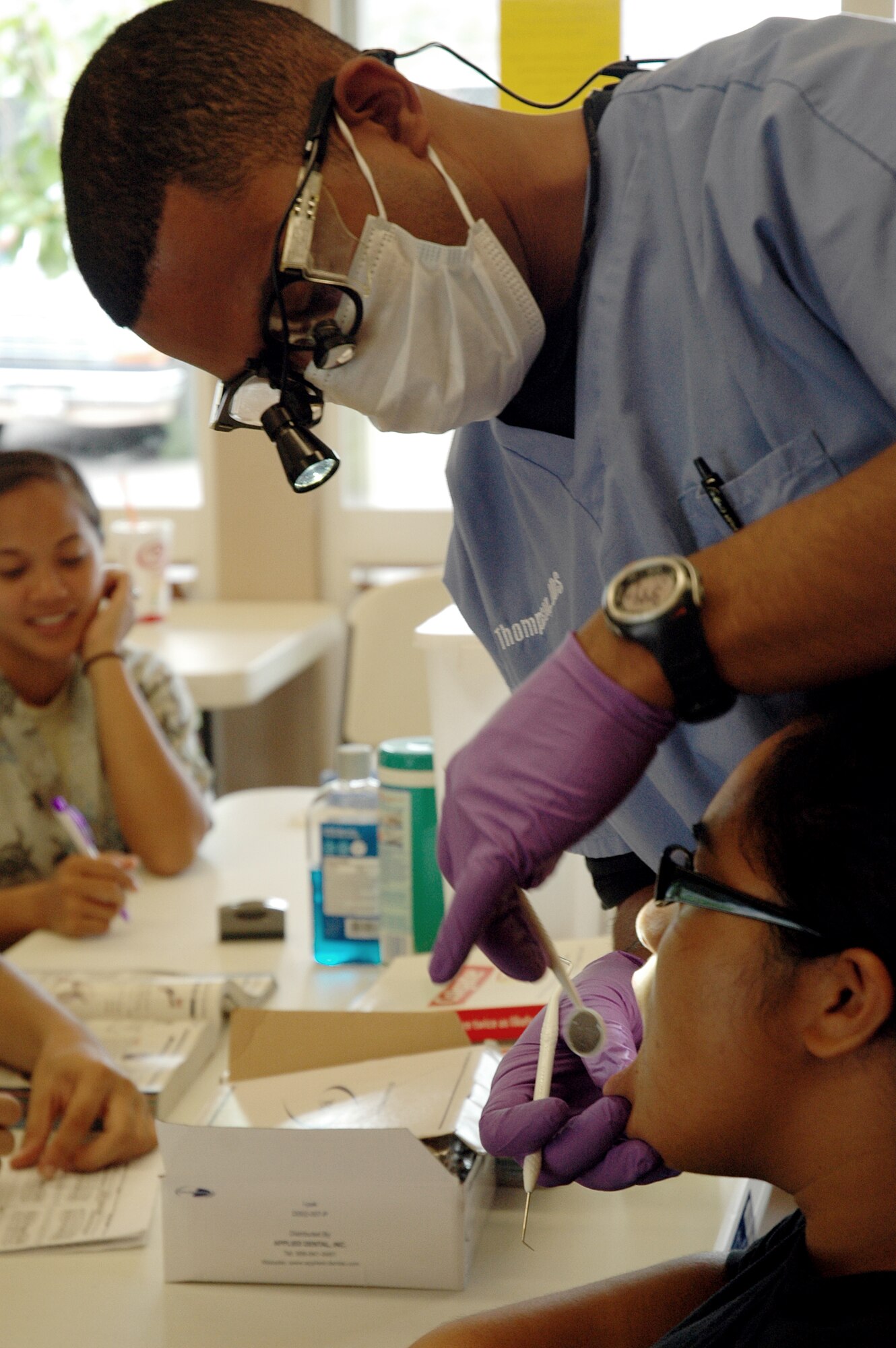 Maj. Stuart Thompson, 154th Medical Group, dentist, inspects child's teeth during Innovative Readiness Training-community outreach in Waianae, Hawaii, July 16. Innovative Readiness Training is an opportunity for Guard members to complete mission essential training while performing free medical services to the community. (U.S. Air Force photo/Tech. Sgt. Betty J. Squatrito-Martin)