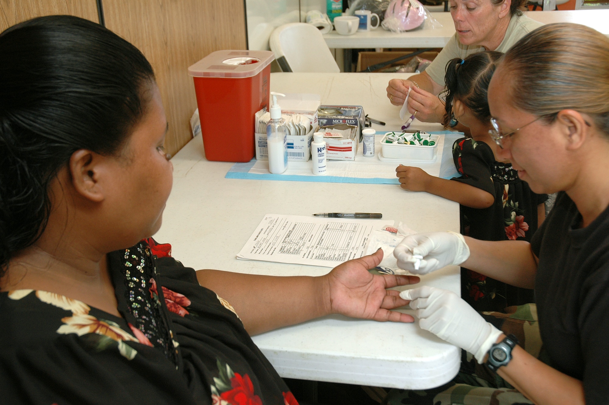 Capt. Elzadia Kainae, clinical nurse, 154th Medical Group administers glucose screening test during Hawaii Medical Innovative Readiness Training July 16, in Waianae, Hawaii. Innovative Readiness Training is designed to give Guard members an opportunity to complete mission essential training while acting as good neighbors addressing community and civic needs. The HI-MIRT took place July 12-17, on the Leeward Coast of Oahu. (U.S. Air Force photo/Tech. Sgt. Betty J. Squatrito-Martin)

