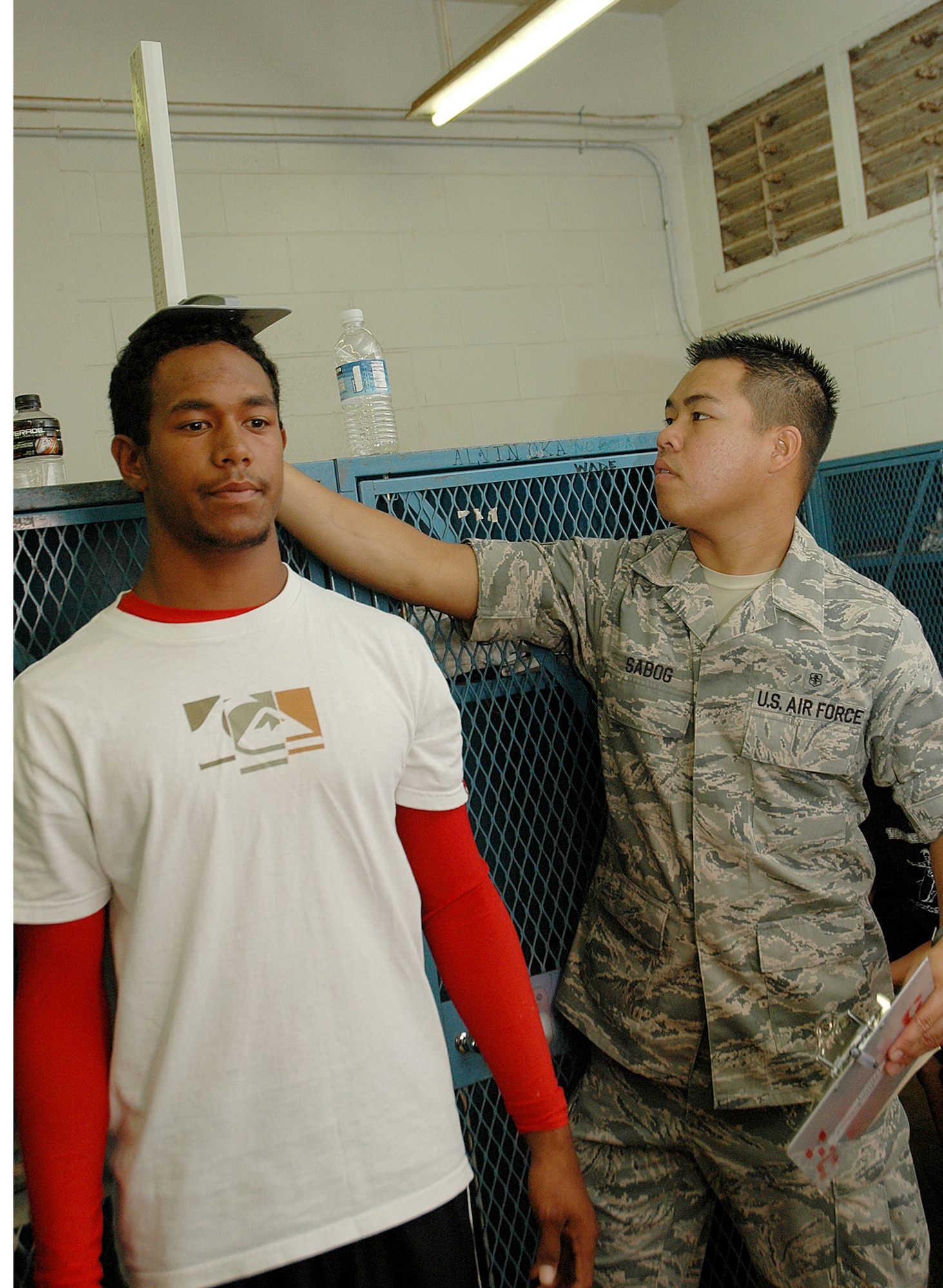 Airman First Class Anthony Sabong, medical technician, 154th Medical Group, Hawaii Air National Guard, measures the height of Waianae High School student athlete during sports physicals given by Air National Guard members at Waianae High School, in Waianae, Hawaii, July 14. The physicals were part of the Innovative Readiness Training that took place from July 12-17, on the Leeward Coast of Oahu.(U.S. Air Force photo/Tech. Sgt. Betty J. Squatrito-Martin)