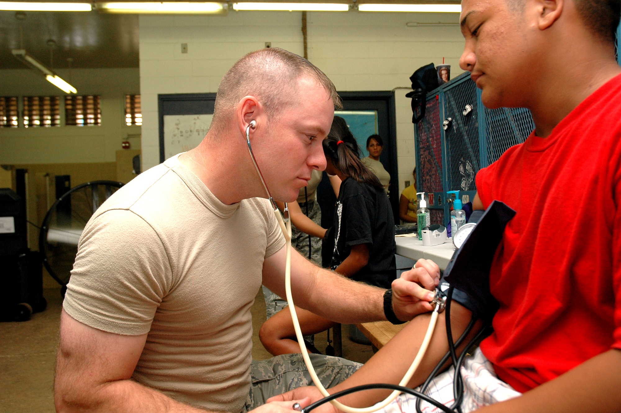 Tech. Sgt. Nate Steele, medical technician, 123rd Airlift Wing, Kentucky Air National Guard, checks blood pressure of a Waianae High School student athlete during sports physicals given by Air National Guard members at Waianae High School in Waianae, Hawaii, July 14. The physicals were part of the Innovative Readiness Training that took place from July 12-17, on the Leeward Coast of Oahu. (U.S. Air Force photo/Tech. Sgt. Betty J. Squatrito-Martin)