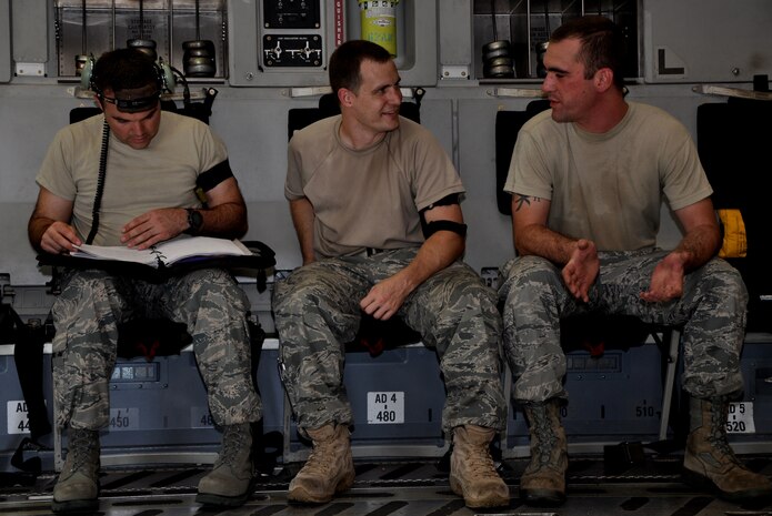 Tech. Sgt. Christopher Shea reviews a VHF antenna write up in the maintenance record of a C-17 Globemaster III July 23, 2010, at Charleston Air Force Base, S.C. Staff Sgt. Charlie Watson and Senior Airman Jonathan Kiger wait patiently to begin working the job. Sergeant Shea and Sergeant Watson are communication and navigation specialist with the 315th Aircraft Maintenance Squadron here, and Senior Airman Kiger is a communication and navigation specialist with the 437th Aircraft Maintenance Squadron here. (U.S. Air Force photo/Staff Sgt. Shane Ellis)