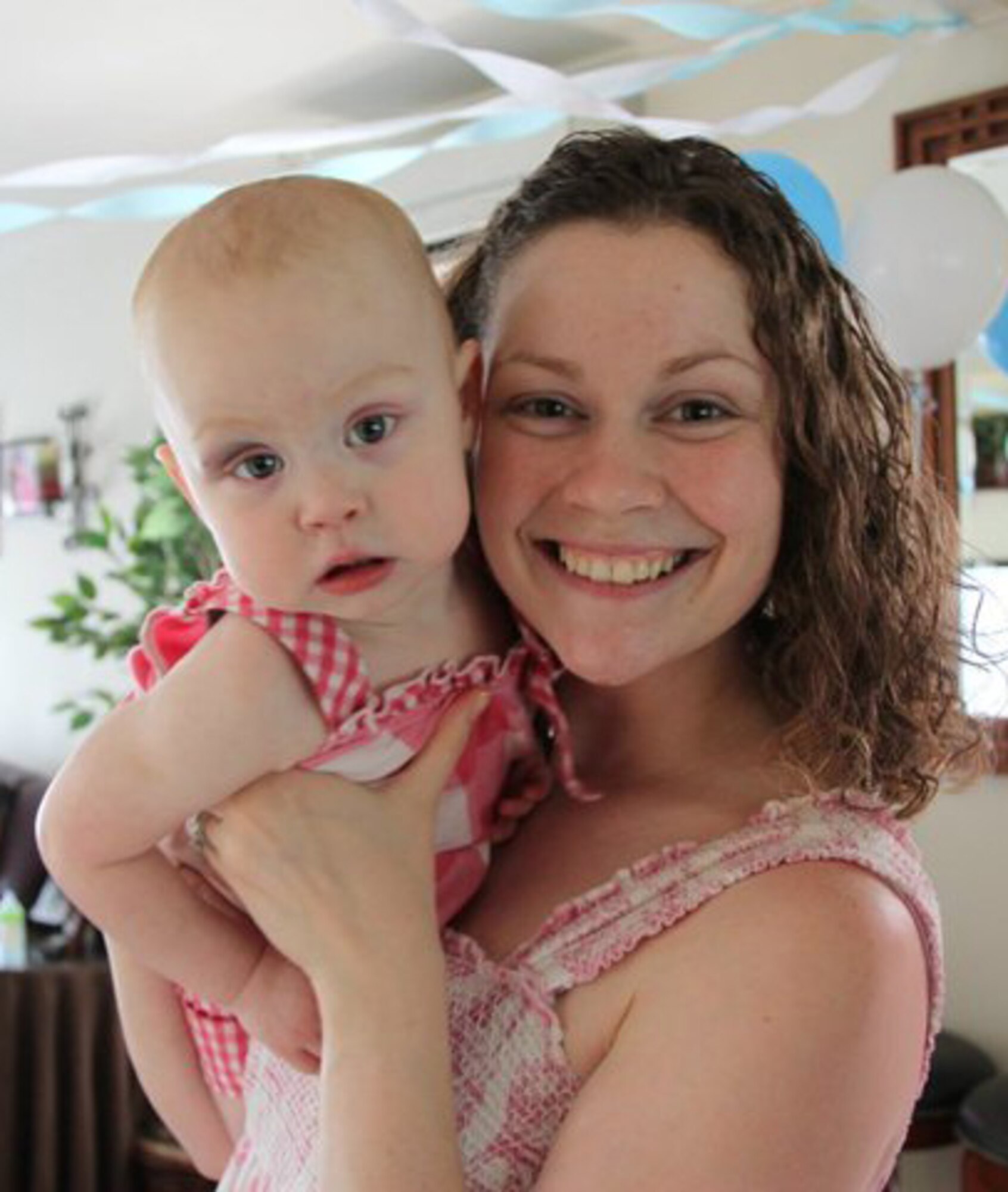 YOKOTA AIR BASE, Japan -- Rachel Brandenburg, wife of Senior Airman Matthew Brandenburg, a pediatrics medical technician for the 374th Medical Group, pictured with daughter, Julie, is part of two "mom's groups" at Yokota Air Base. Yokota offeres a variety of classes and groups for mothers of young children and infants.