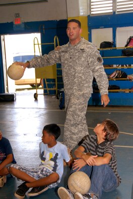 Specialist, Bruce Blanton, Counterdrug, Hawaii National Guard, explains the "Monkey Feet" rules to students at V.S.A. Benavente Middle School on Guam, June 29, during a Drug Demand Reduction program. "Monkey Feet," is an activity designed to develop teamwork and communication skills. (U.S. Air Force photo/Tech. Sgt. Betty J. Squatrito-Martin)