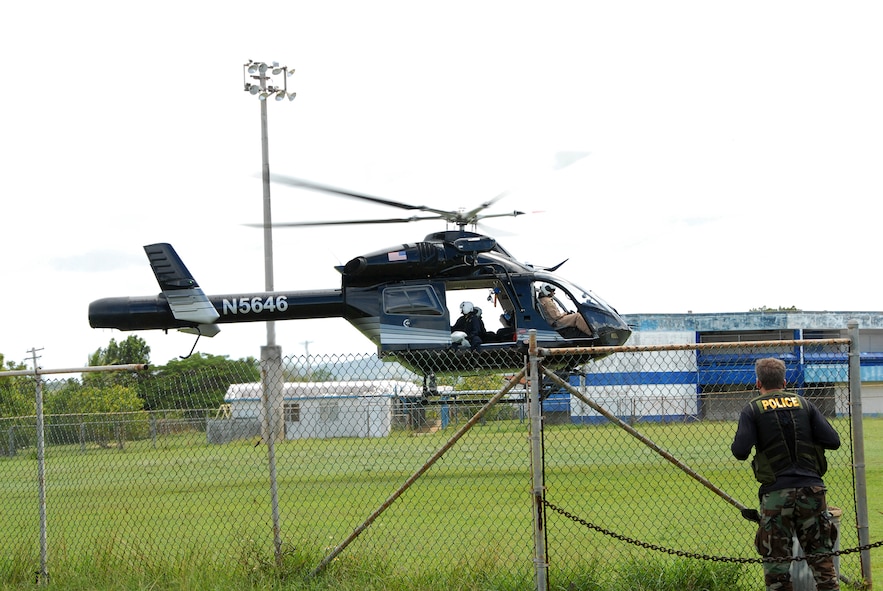 A law enforcement agent waits for the Drug Enforcement Administration helicopter to land during the DEA led Marijuana Eradication Mission held on Tinian and Guam June 30-Jul 2. The aircrew will handoff marijauna plants that were confiscated during the mission to the awaiting agent. Law enforcement agents along with Counterdrug personnel confiscated and destroyed hundreds of illicit plants during the three day operation. (U.S. Air Force photo/Tech. Sgt. Betty J. Squatrito-Martin) 