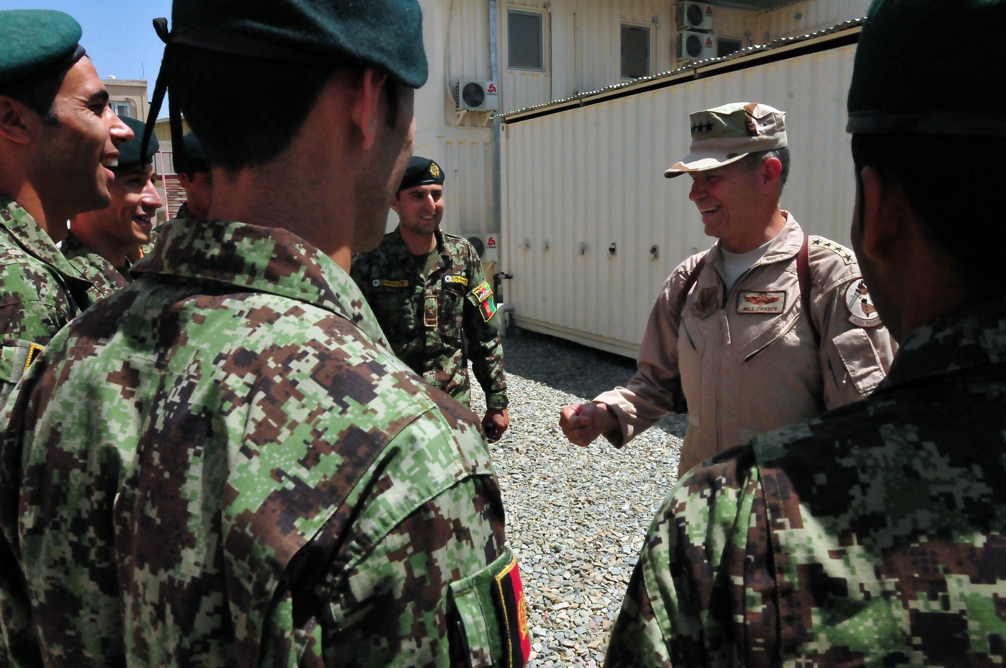 100723-N-6031Q-011 KABUL, Afghanistan - Gen. William M. Fraser III, Commander of the Air Combat Command, talks with the Afghan 2nd Lieutenants when he visited the Afghan Air Force Base in Kabul on July 23, 2010. Fraser, along with Lt. Gen. Michael Hostage, U.S. Air Forces Central commander, toured the "Thunder Lab", an English immersion program for Afghan pilot candidates. Fraser also toured the living quarters and demonstrated his own pilot skills on the Rotary Wing flight simulator. The visit gave Fraser the opportunity to meet various service members working with the Combined Air Power Transition Force as well as Gen. Darwan, Commanding General of the Afghan Air Force. (US Navy photo by Mass Communication Specialist 2nd Class David Quillen/ RELEASED).