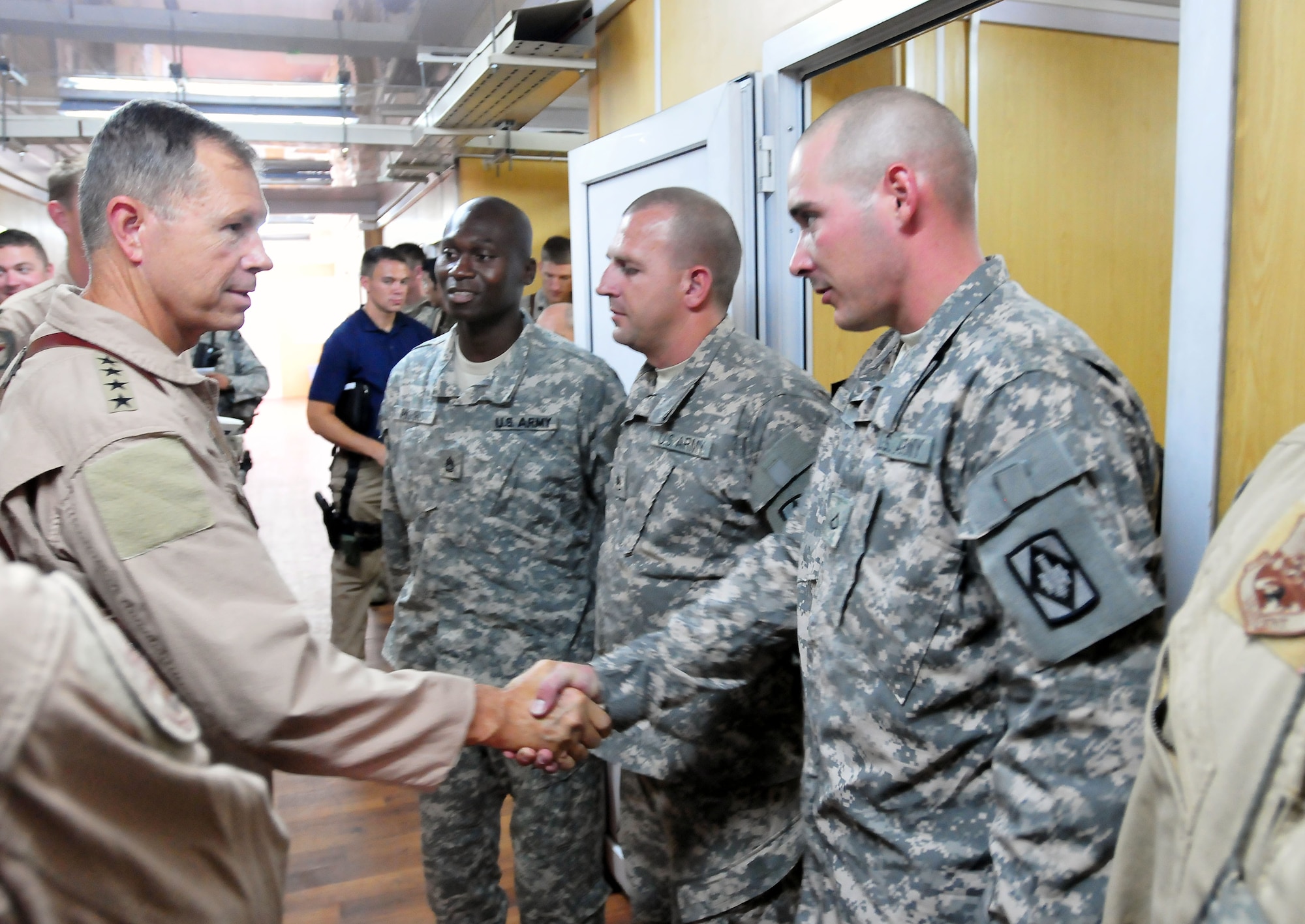 100723-N-6031Q-008 KABUL, Afghanistan - Gen. William M. Fraser III, Commander of the Air Combat Command, shakes hands with the troops when he visited the Afghan Air Force Base in Kabul on July 23, 2010. Fraser, along with Lt. Gen. Michael Hostage, U.S. Air Forces Central commander, toured the "Thunder Lab", an English immersion program for Afghan pilot candidates. Fraser also toured the living quarters and demonstrated his own pilot skills on the Rotary Wing flight simulator. The visit gave Fraser the opportunity to meet various service members working with the Combined Air Power Transition Force as well as Gen. Darwan, Commanding General of the Afghan Air Force. (US Navy photo by Mass Communication Specialist 2nd Class David Quillen/ RELEASED).