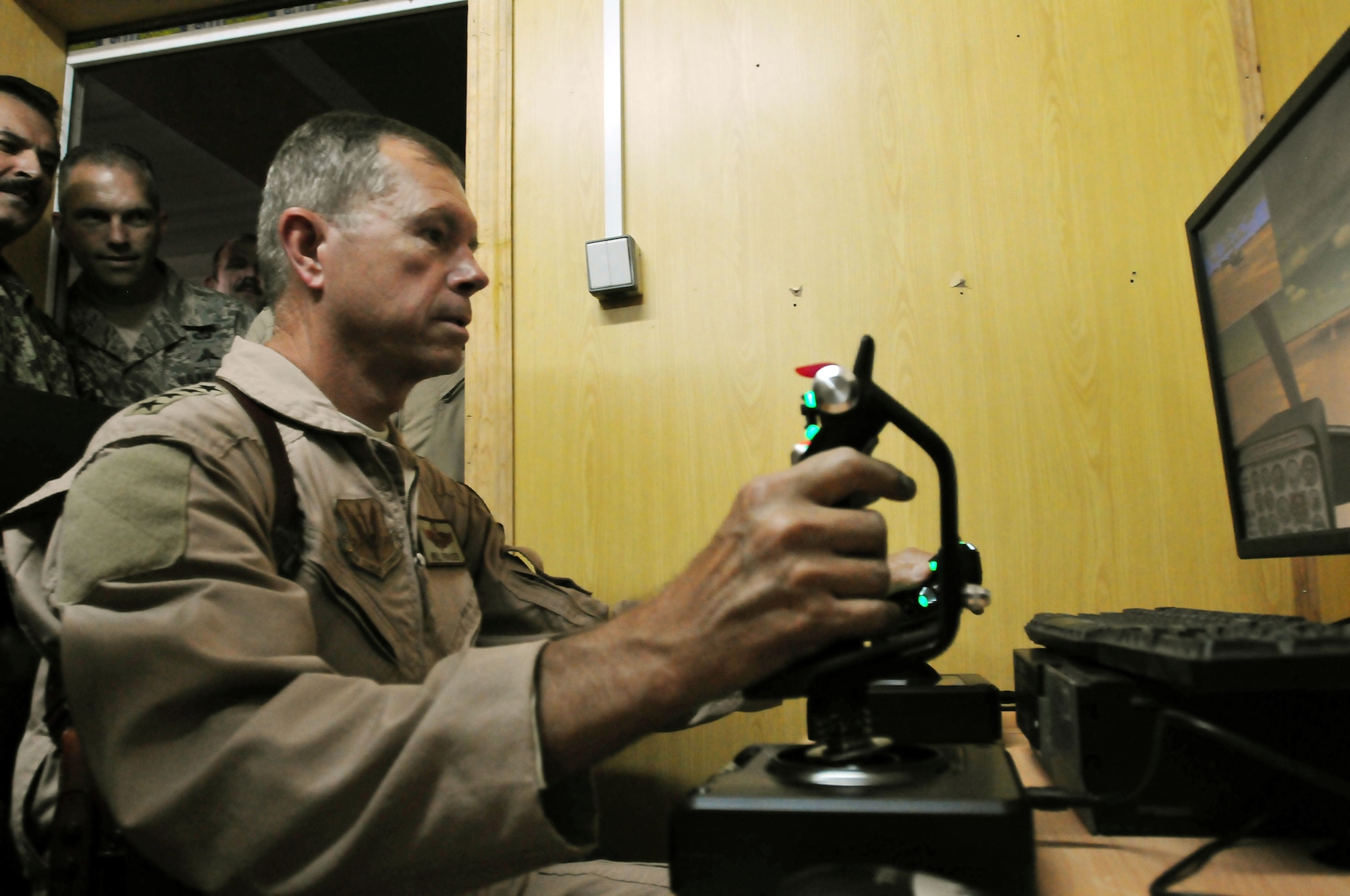100723-N-6031Q-007 KABUL, Afghanistan - Gen. William M. Fraser III, Commander of the Air Combat Command, demonstrated his own pilot skills on the Rotary Wing flight simulator during visited the Afghan Air Force Base in Kabul on July 23, 2010. Fraser, along with Lt. Gen. Michael Hostage, U.S. Air Forces Central commander, toured the "Thunder Lab", an English immersion program for Afghan pilot candidates. Fraser also toured the living quarters. The visit gave Fraser the opportunity to meet various service members working with the Combined Air Power Transition Force as well as Gen. Darwan, Commanding General of the Afghan Air Force. (US Navy photo by Mass Communication Specialist 2nd Class David Quillen/ RELEASED).